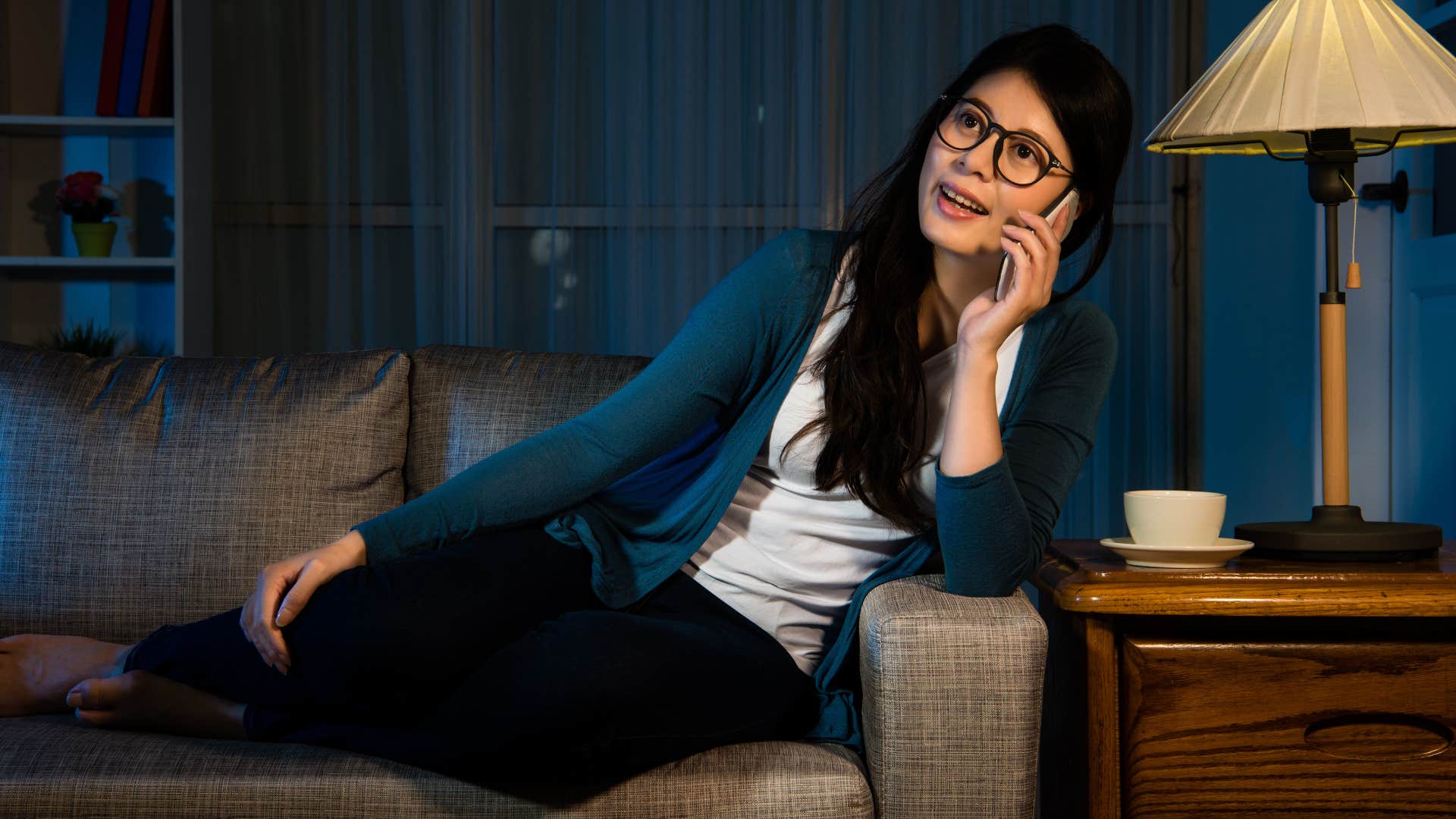 Woman calling co-workers after hours at home.