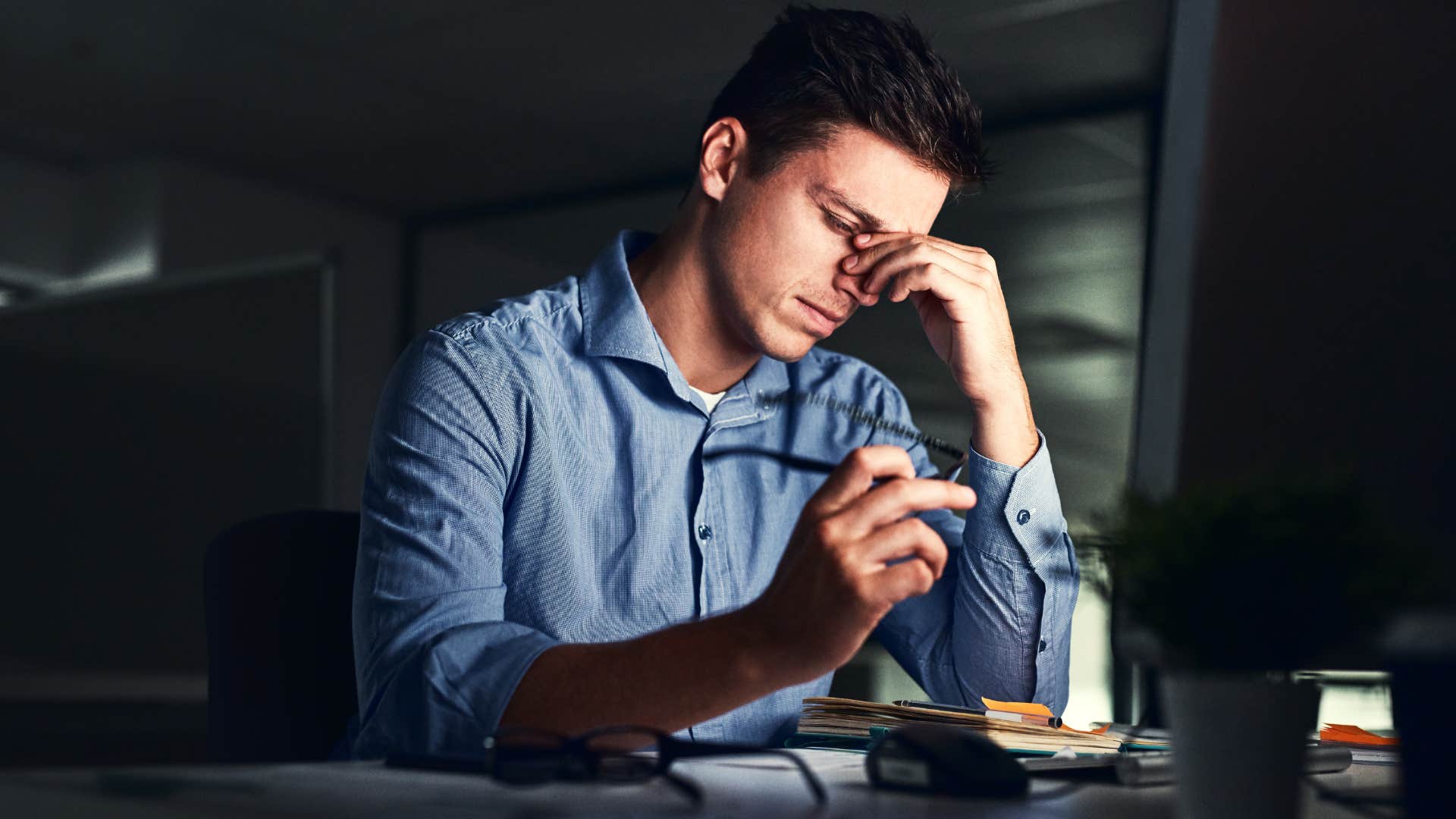 Man working late and feeding into hustle culture.