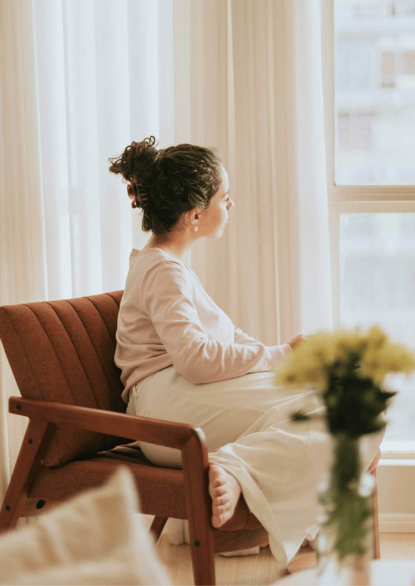 thoughtful woman looking out of window