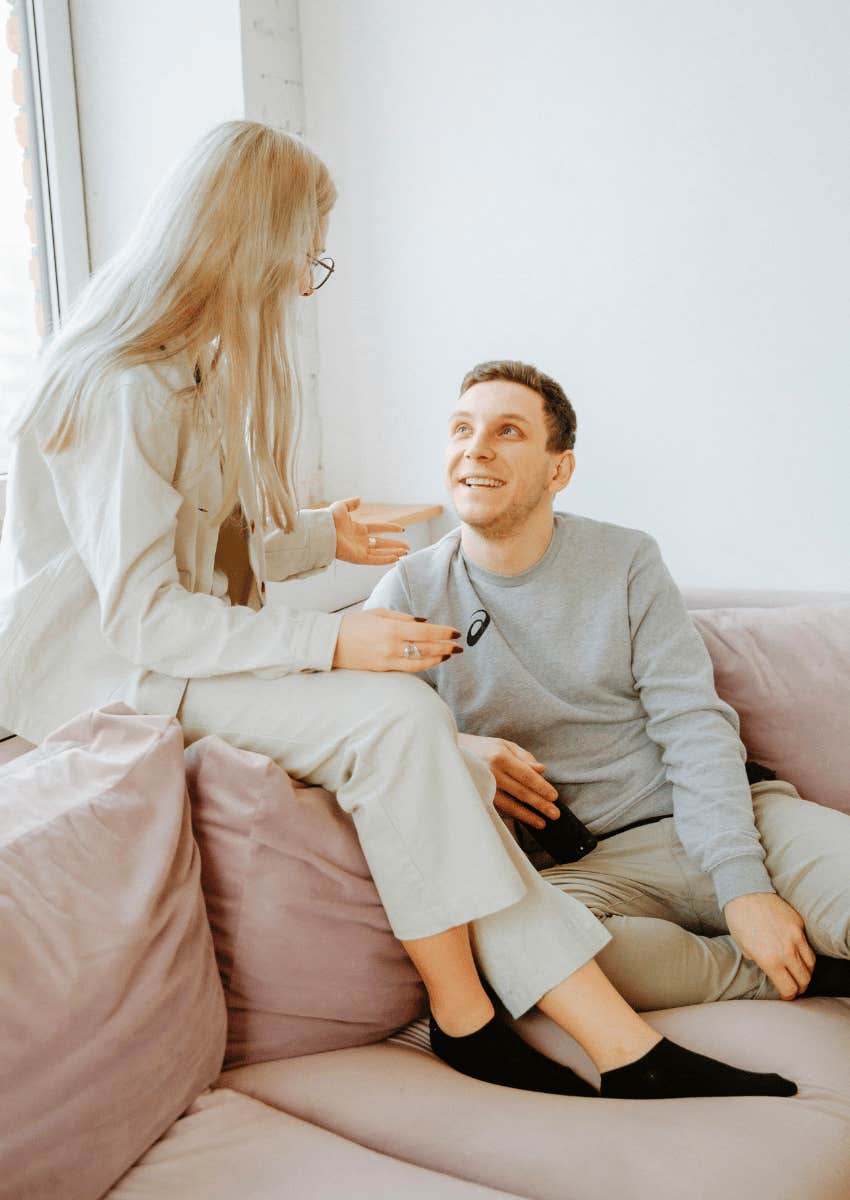 two friends talking while sitting on the couch