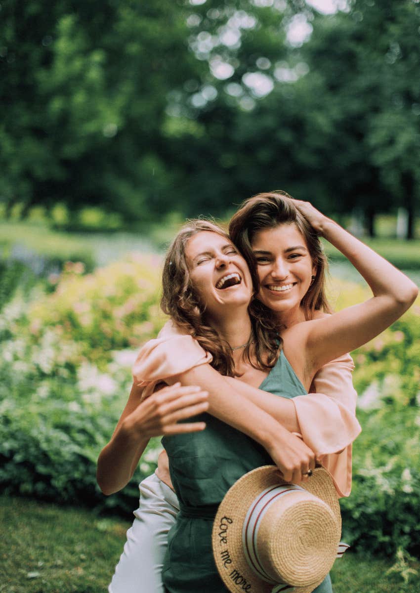 two happy friends hugging each other matching energy