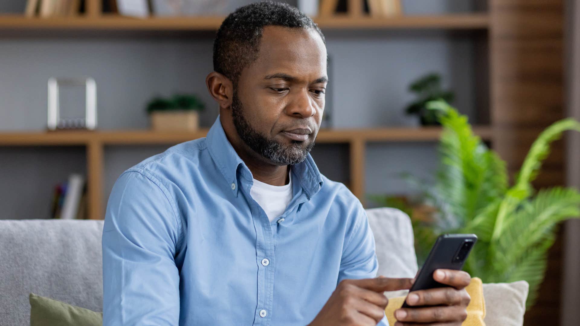 man who always reaches out first texting on his phone