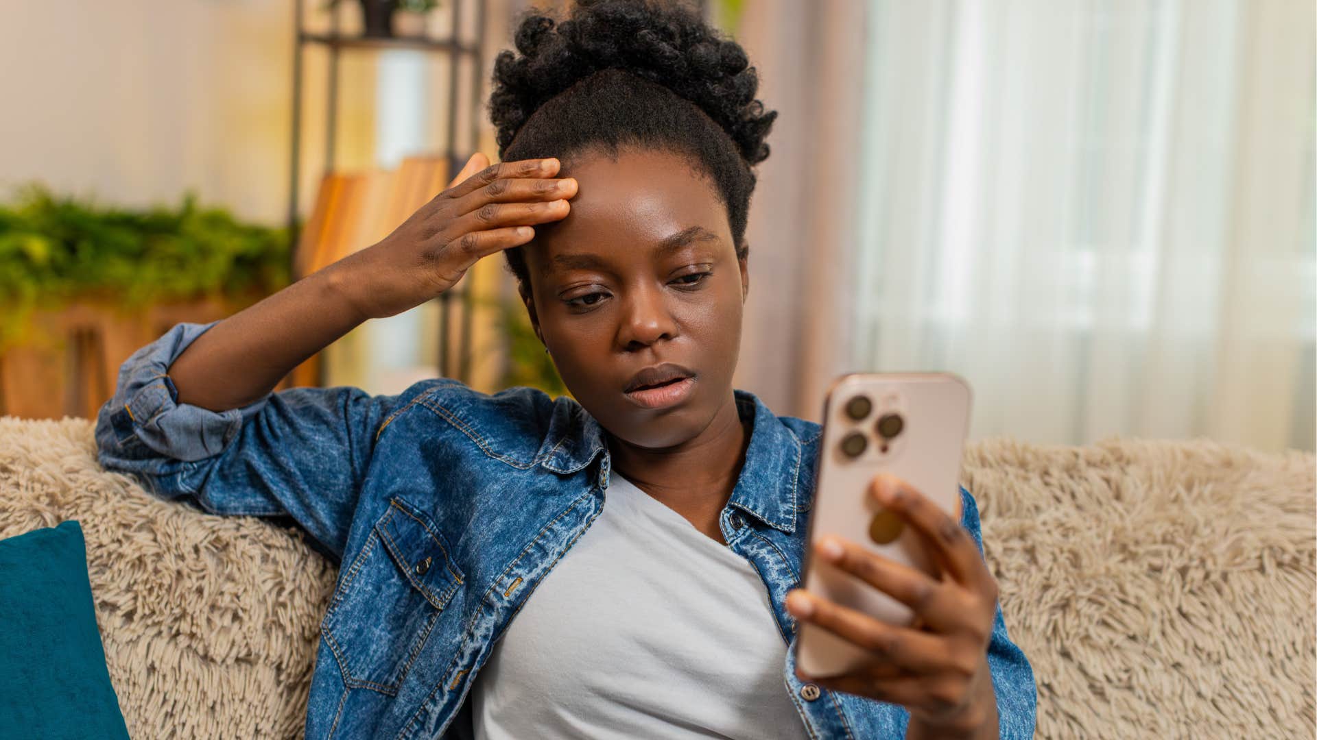 woman looking at phone feeling relieved at canceled plans