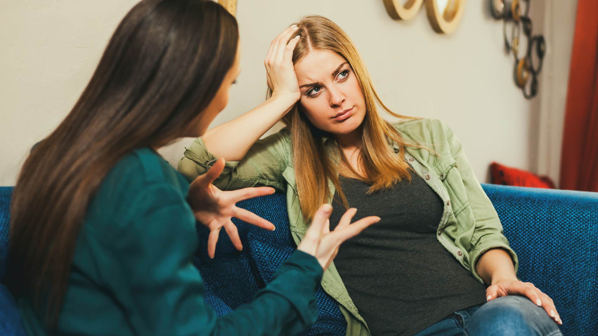 woman sitting with friend who makes jokes at her expense