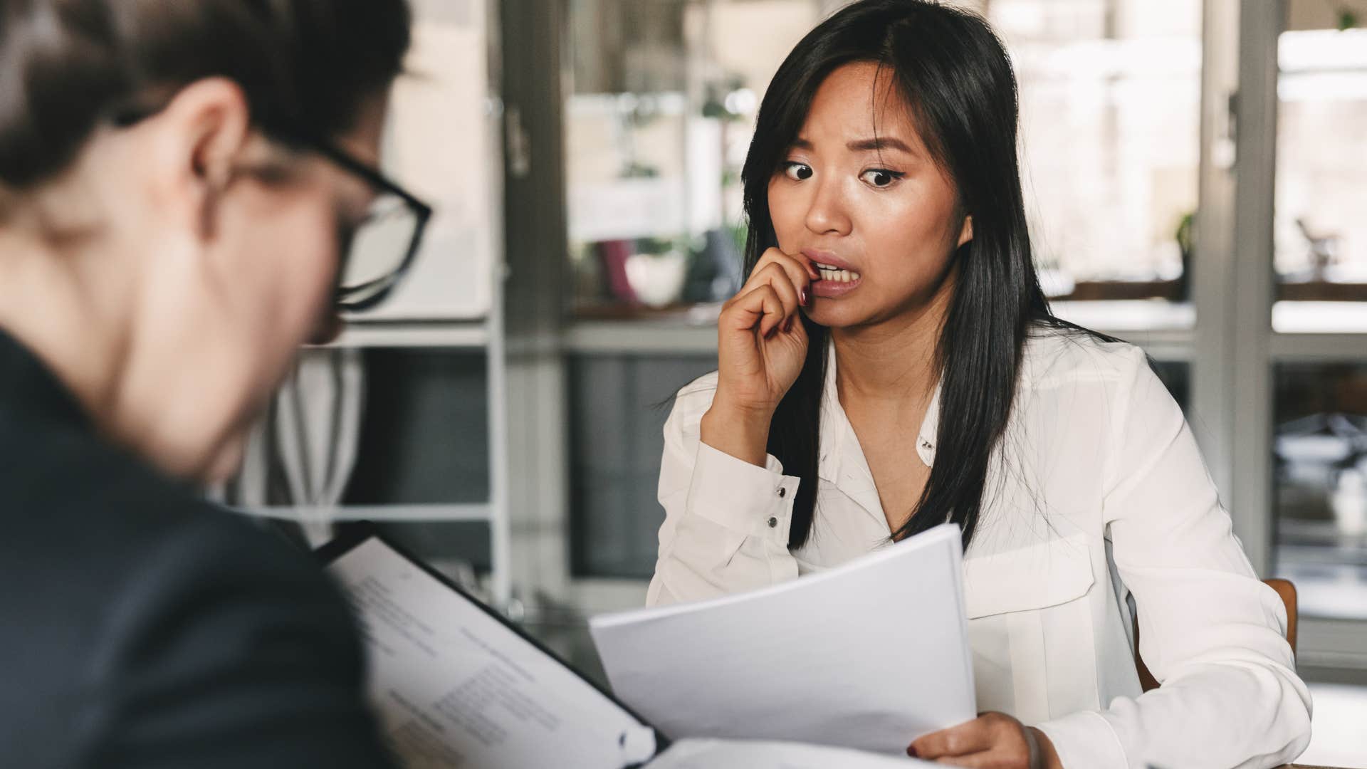 worried woman walking on eggshells around toxic co-worker