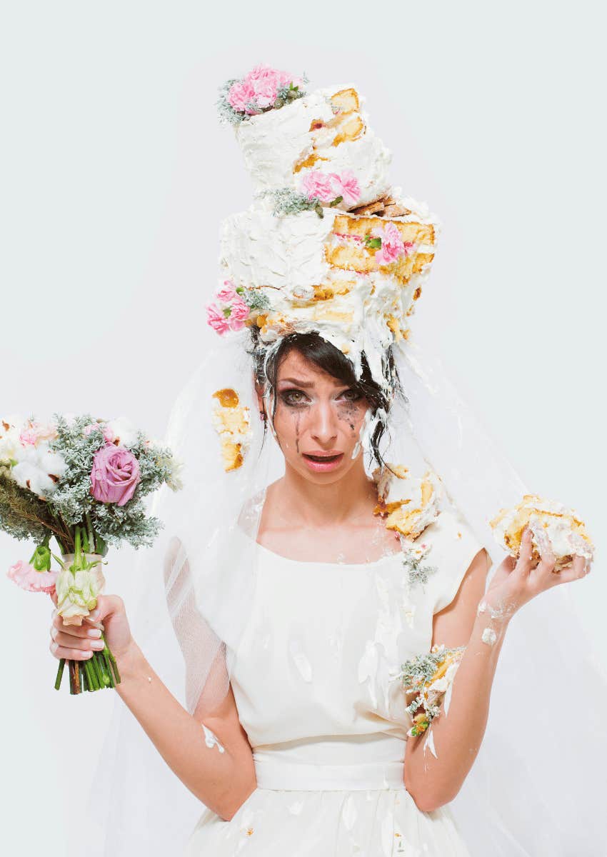 unhappy bride with cake on her head