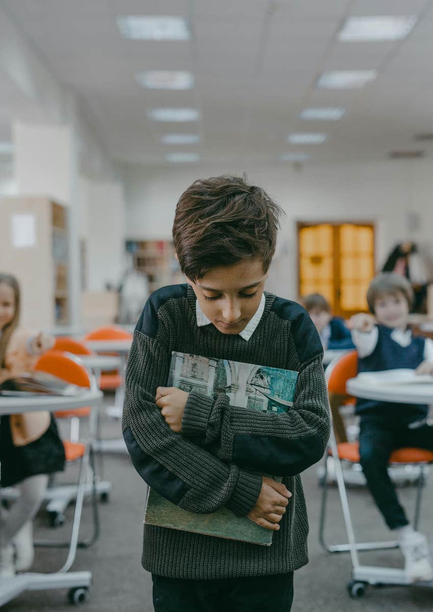 boy being bullied by classmates at school