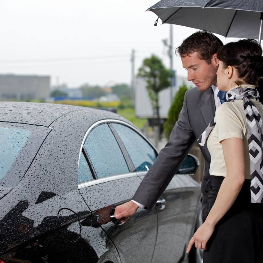 chivalrous man walking woman to the car in the rain
