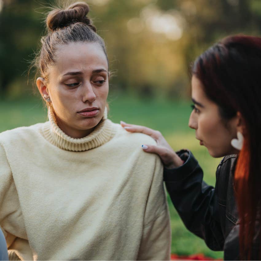 Woman sitting with a friend who's compassionate even in the face of hardship.