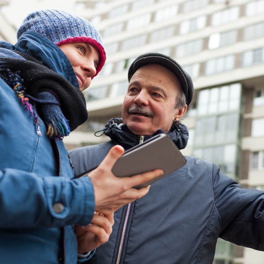 Man doing a small act of kindness on the street.