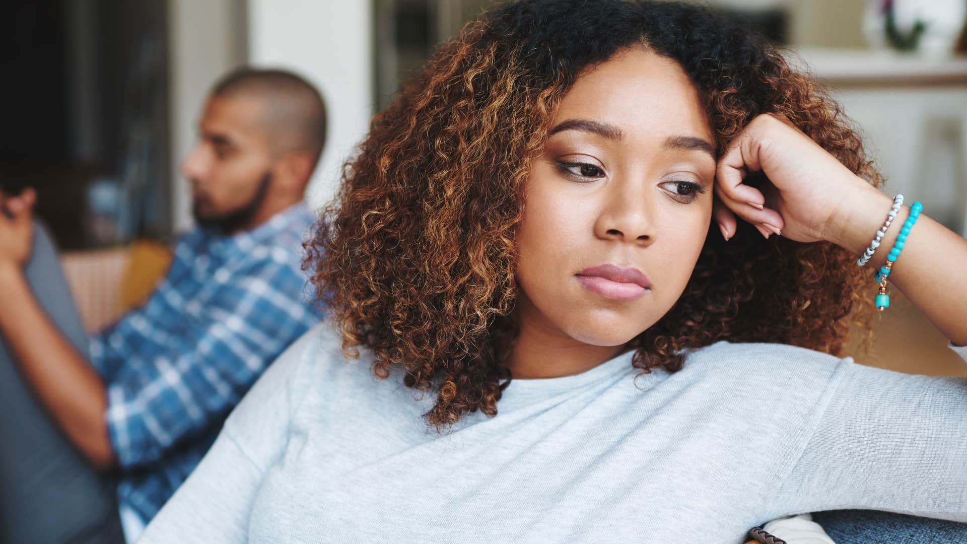 Woman avoiding checking in with her partner at home.