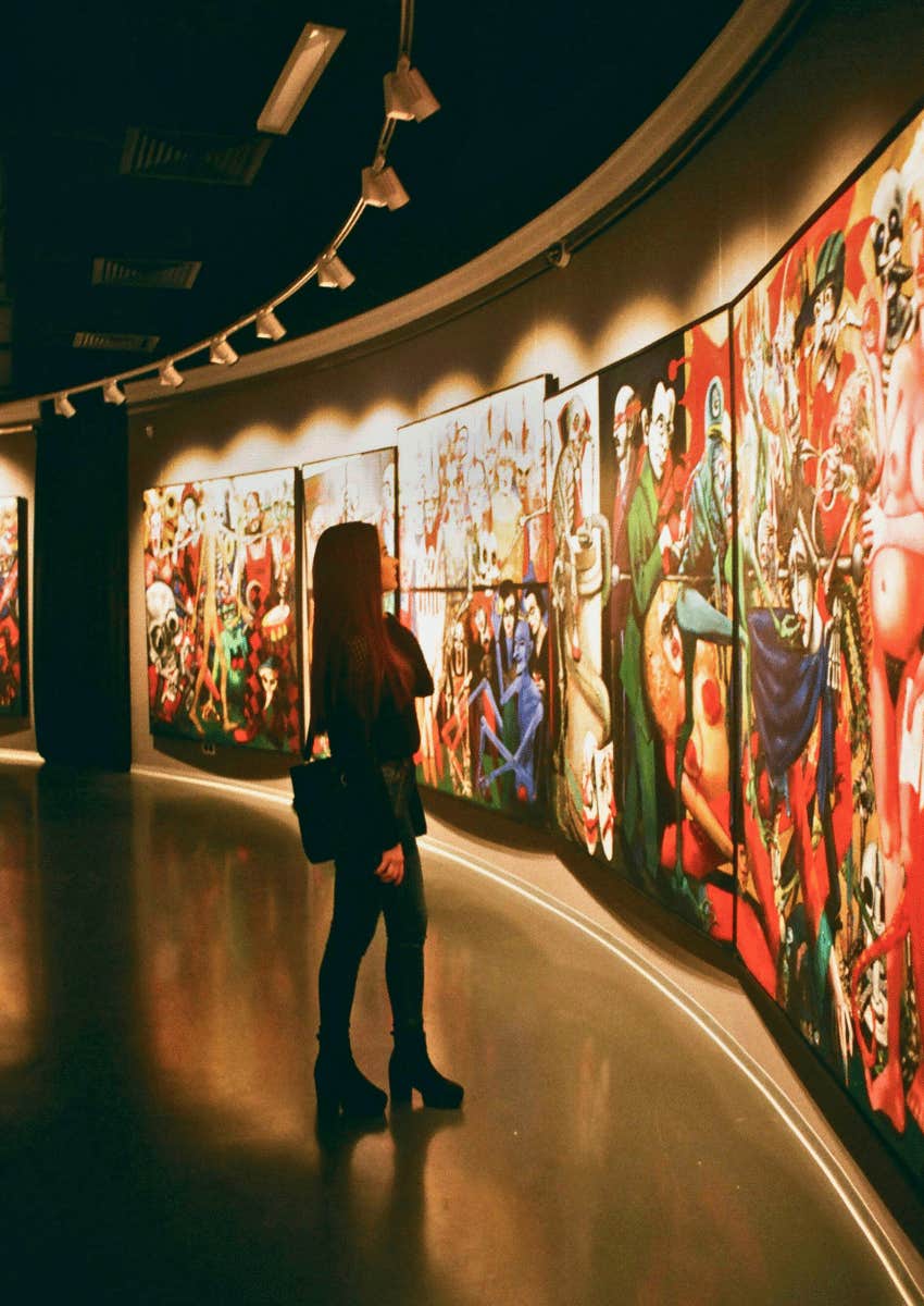 woman appreciating wall art pieces