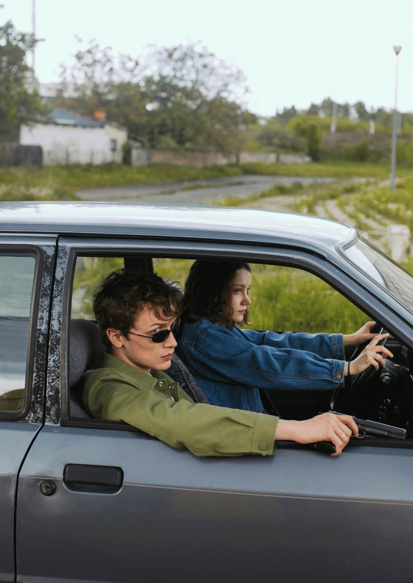 woman driving car with a man in the passenger seat