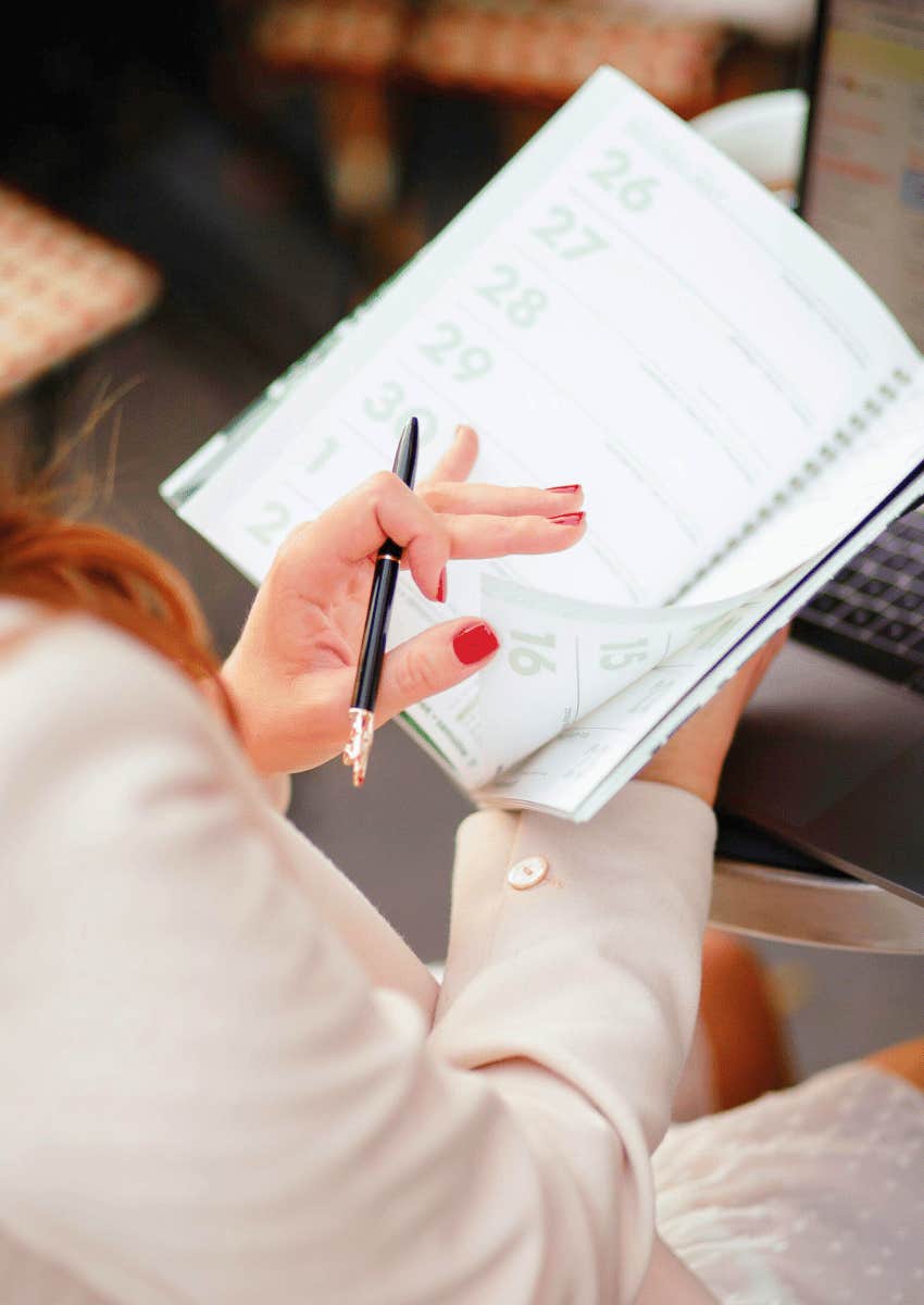 woman flipping through a personal planner