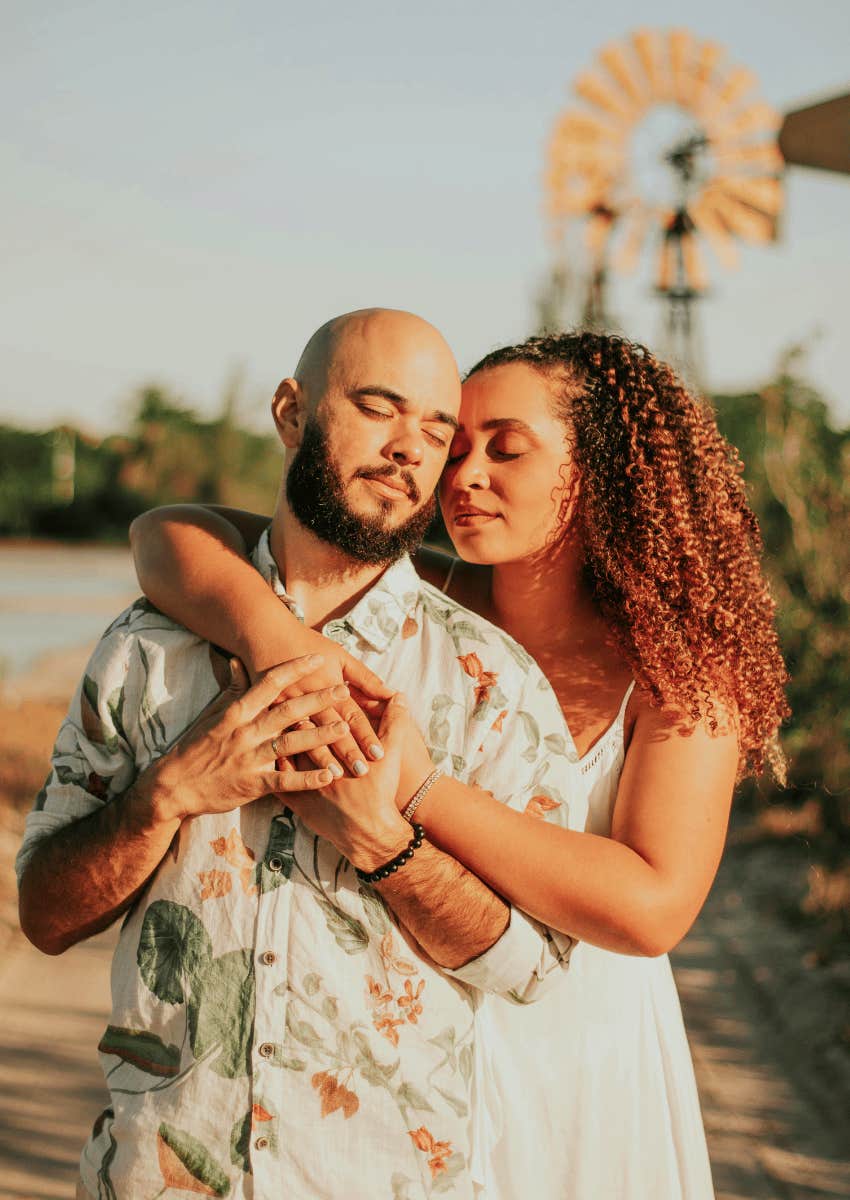 woman hugging man close
