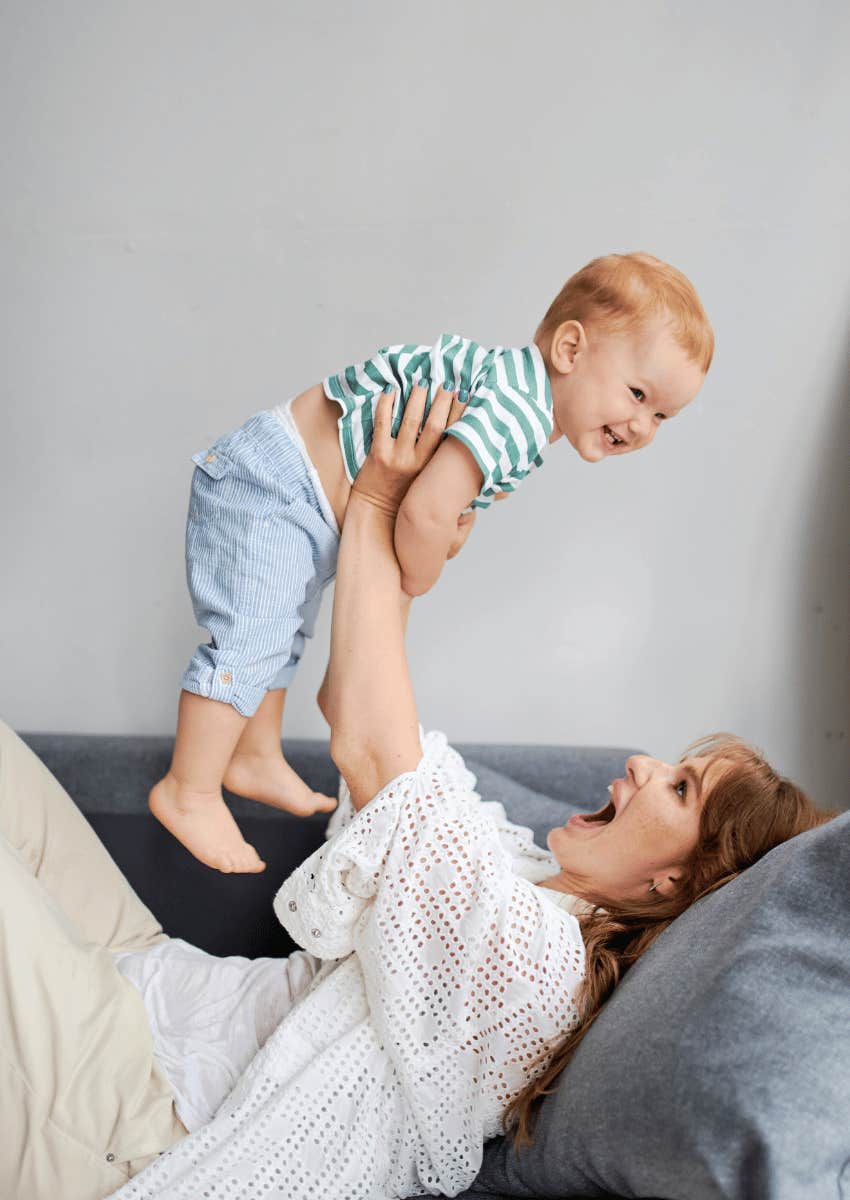 woman lifting smiling child