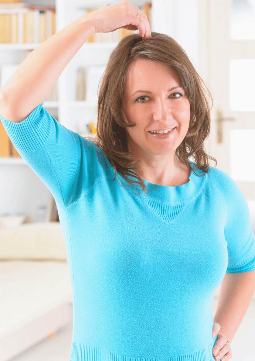 woman showing eft acupressure point at crown of head