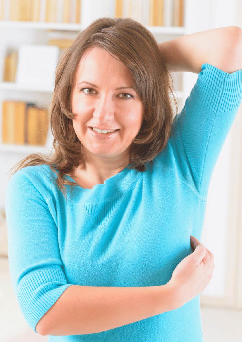 woman showing eft acupressure point under armpit