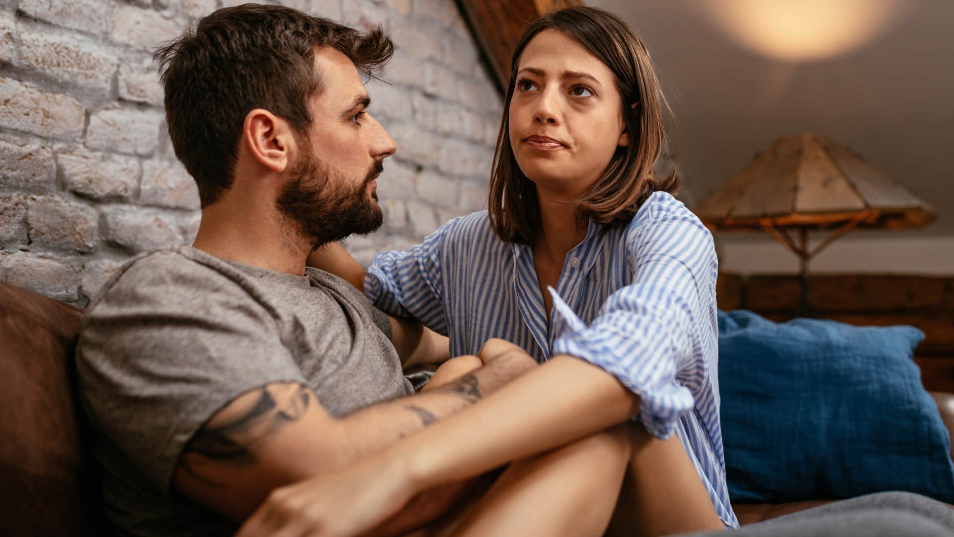 Man who apologizes genuinely sitting with his wife.