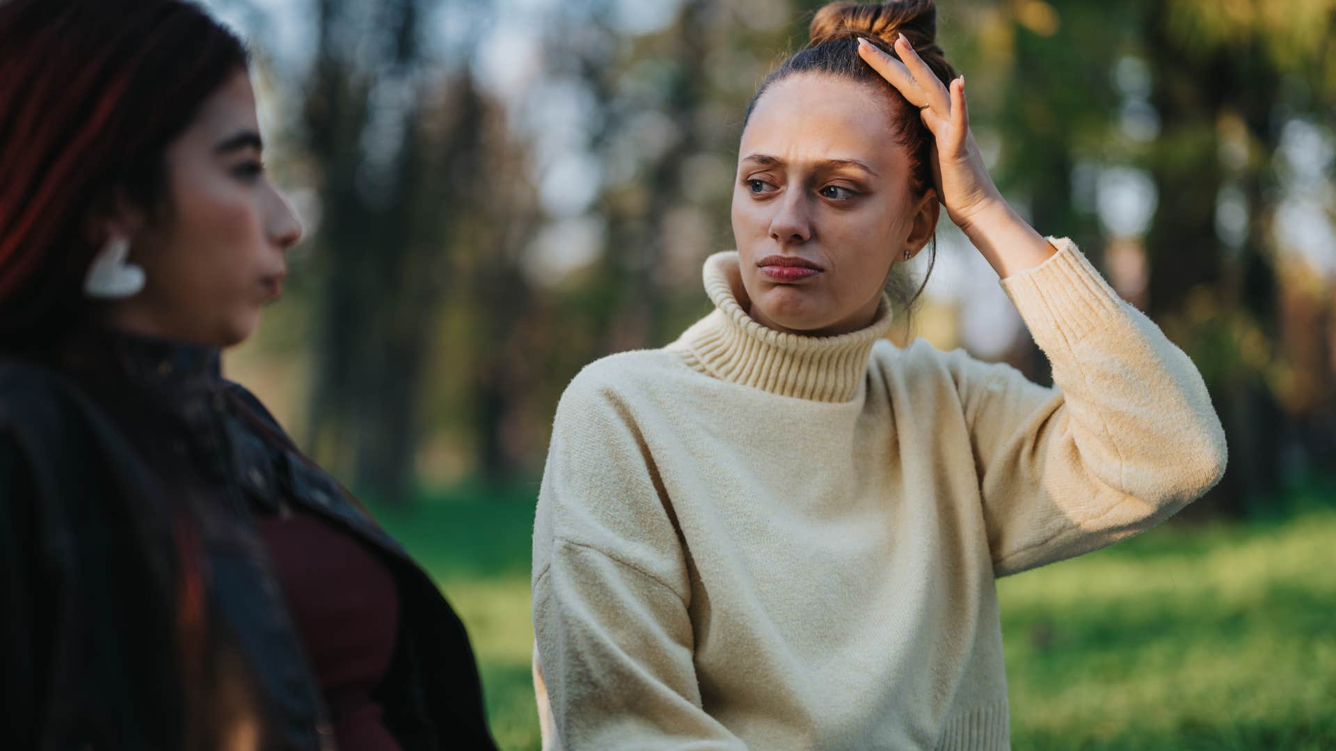 woman oversharing with a friend sitting outside