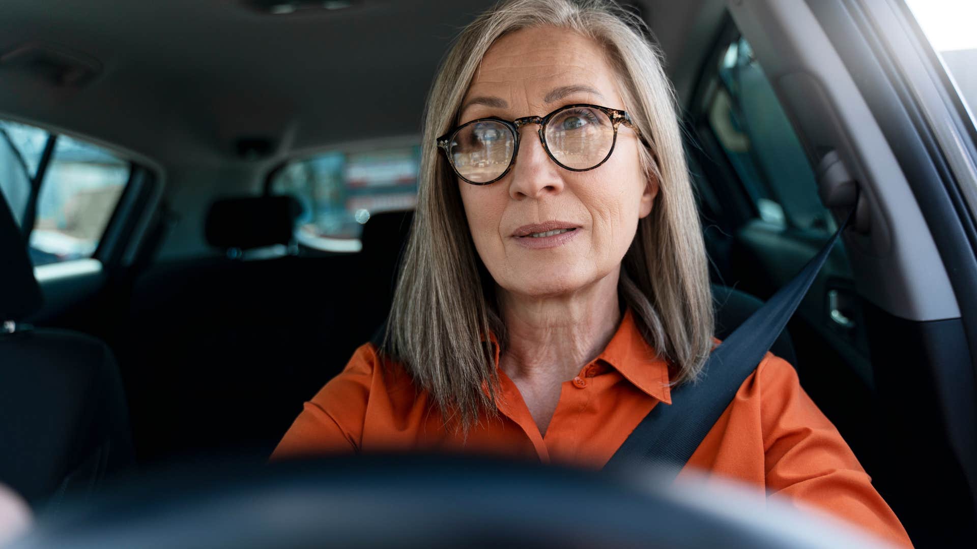 Woman who has social awareness driving her car.