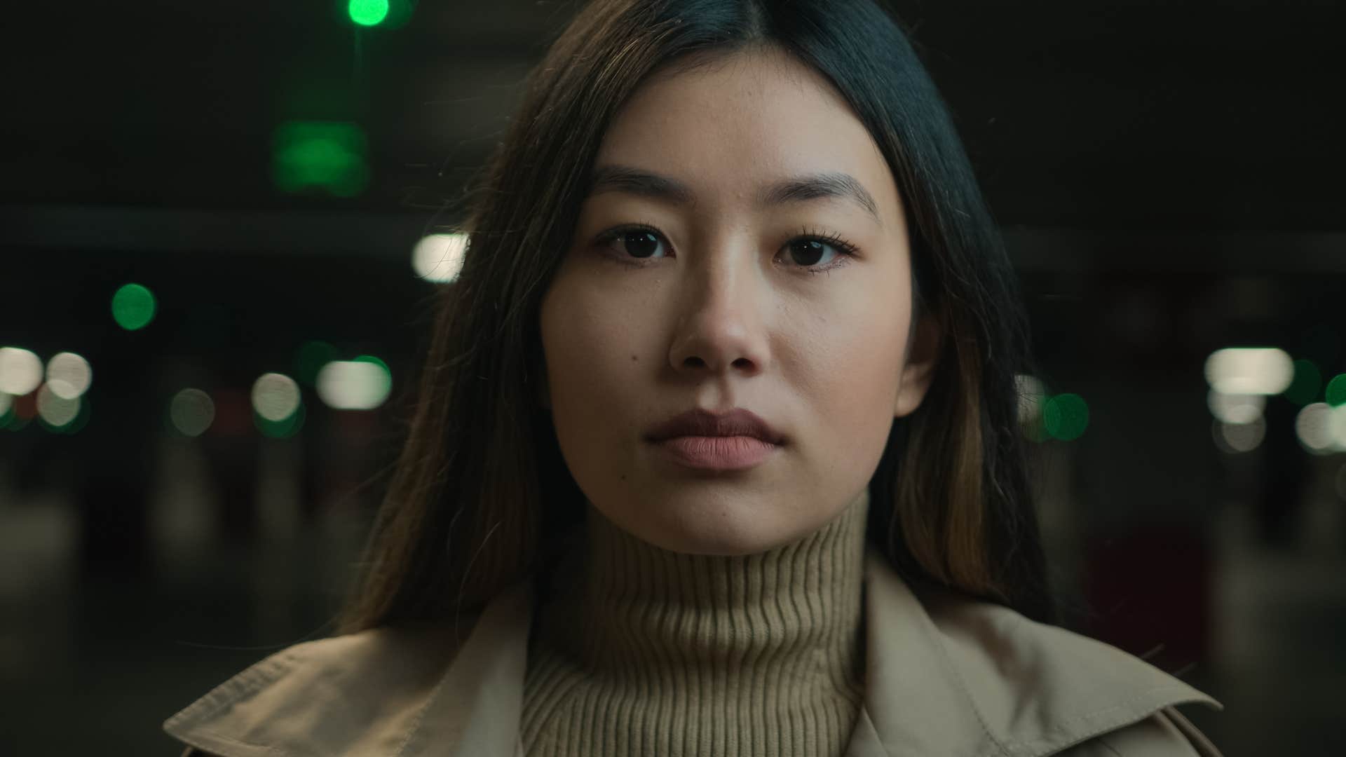 Woman who trusts her instincts standing outside in the dark.