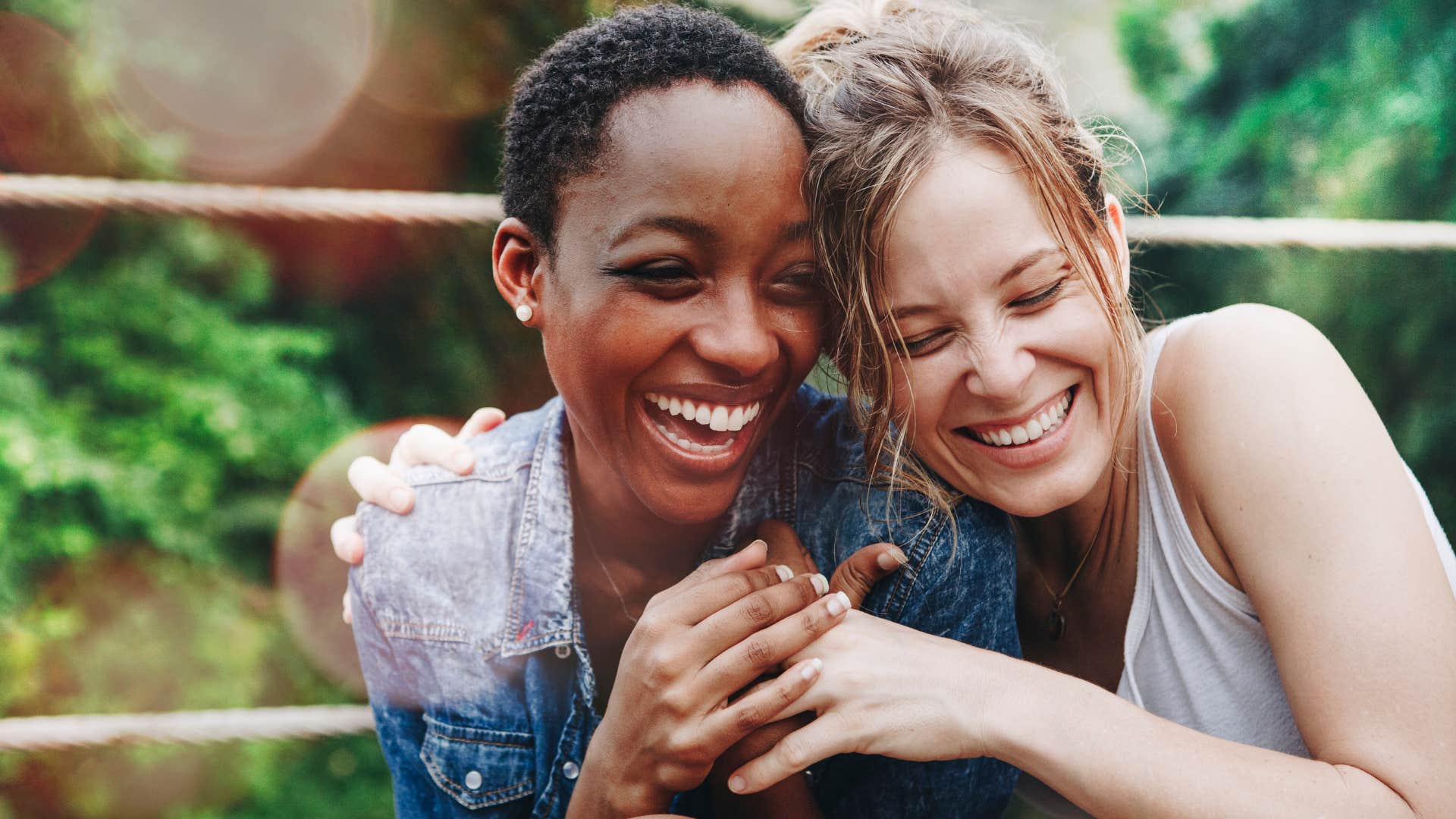 ambitious women smiling and hugging outside