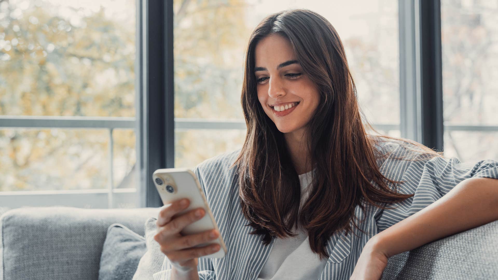 emotionally present woman on her phone smiling