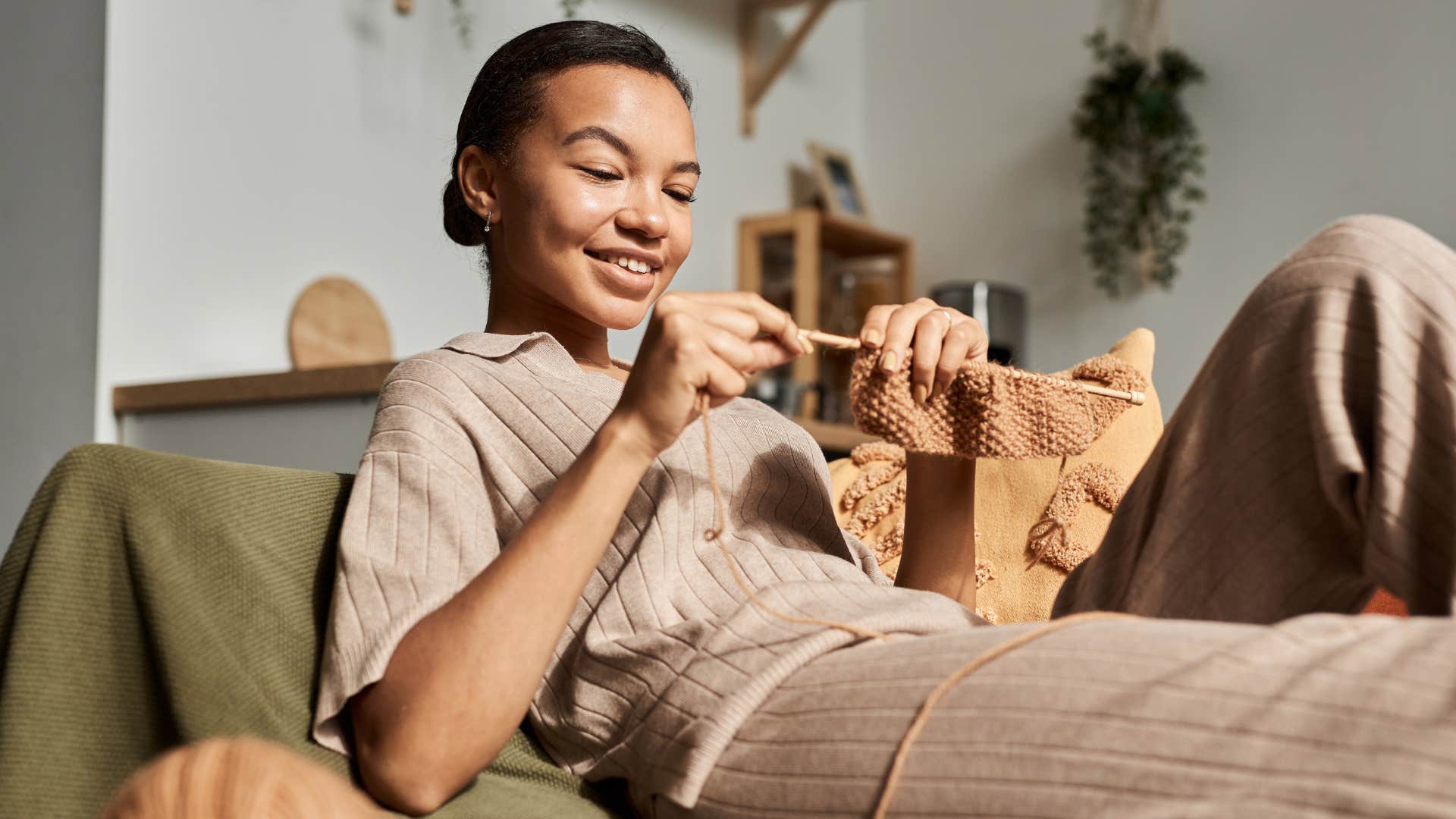 woman internally gratified spending time at home knitting