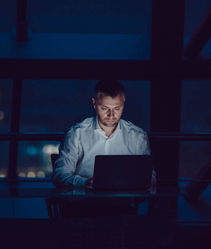 heartbroken man working late