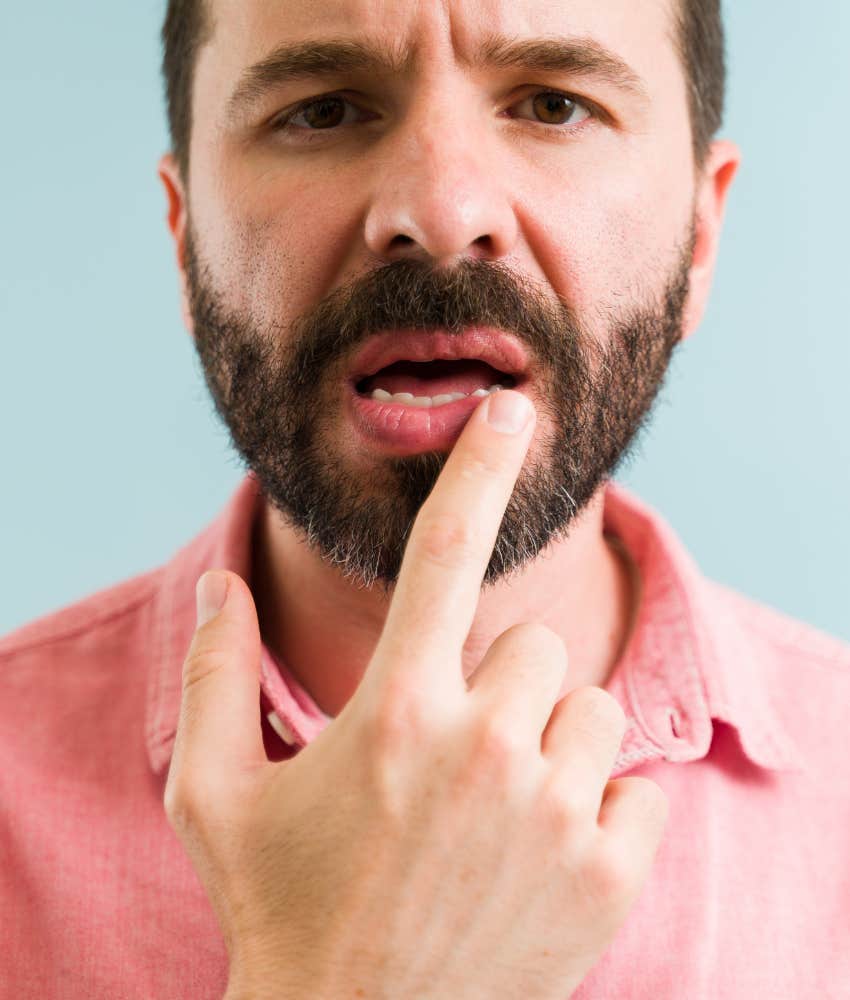 Concerned person touches mouth showing inflammation from bad teeth