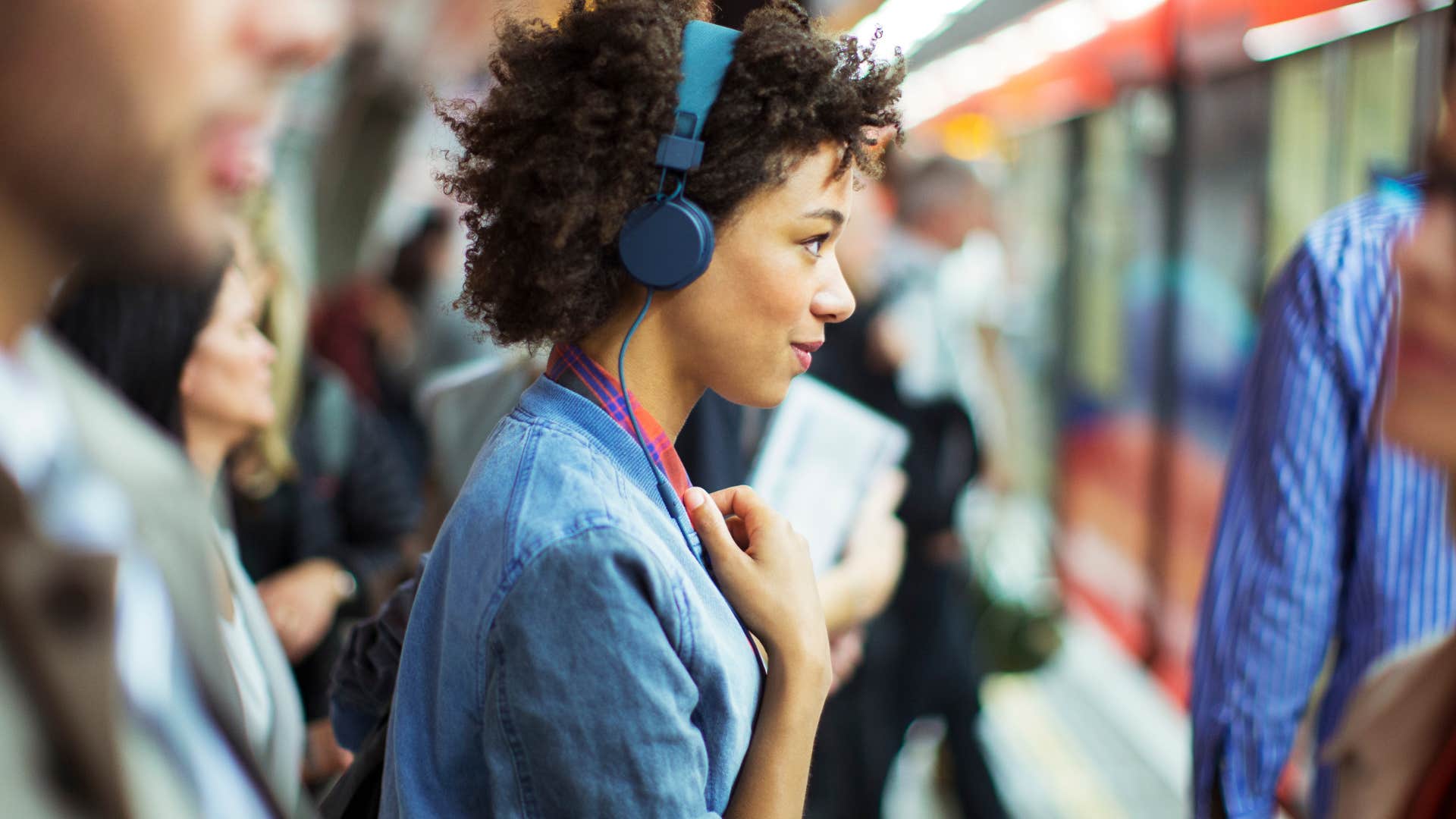 Woman who blocks entryways and doorways standing on a train.