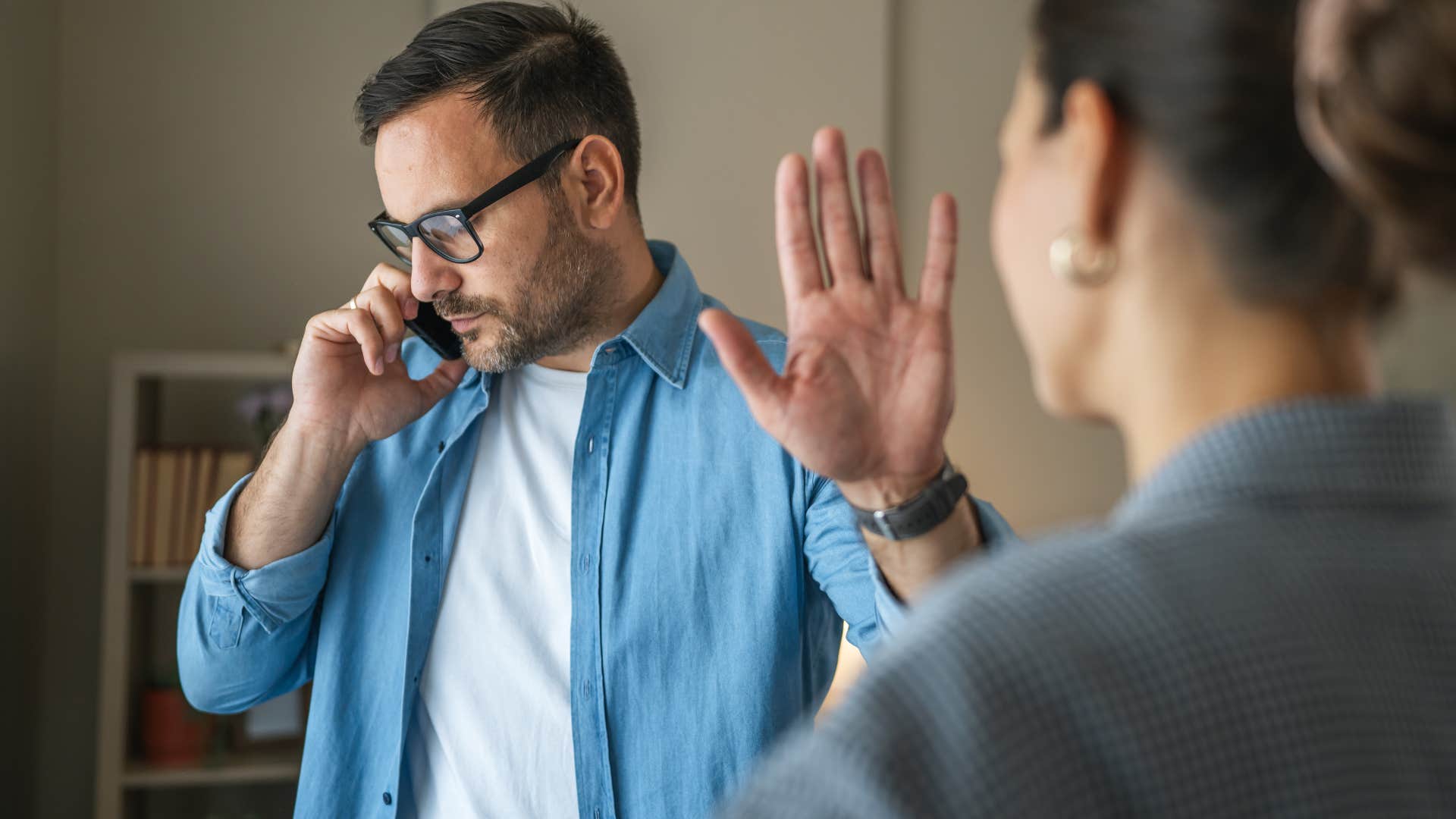 Man who interrupts in conversations talking on the phone.