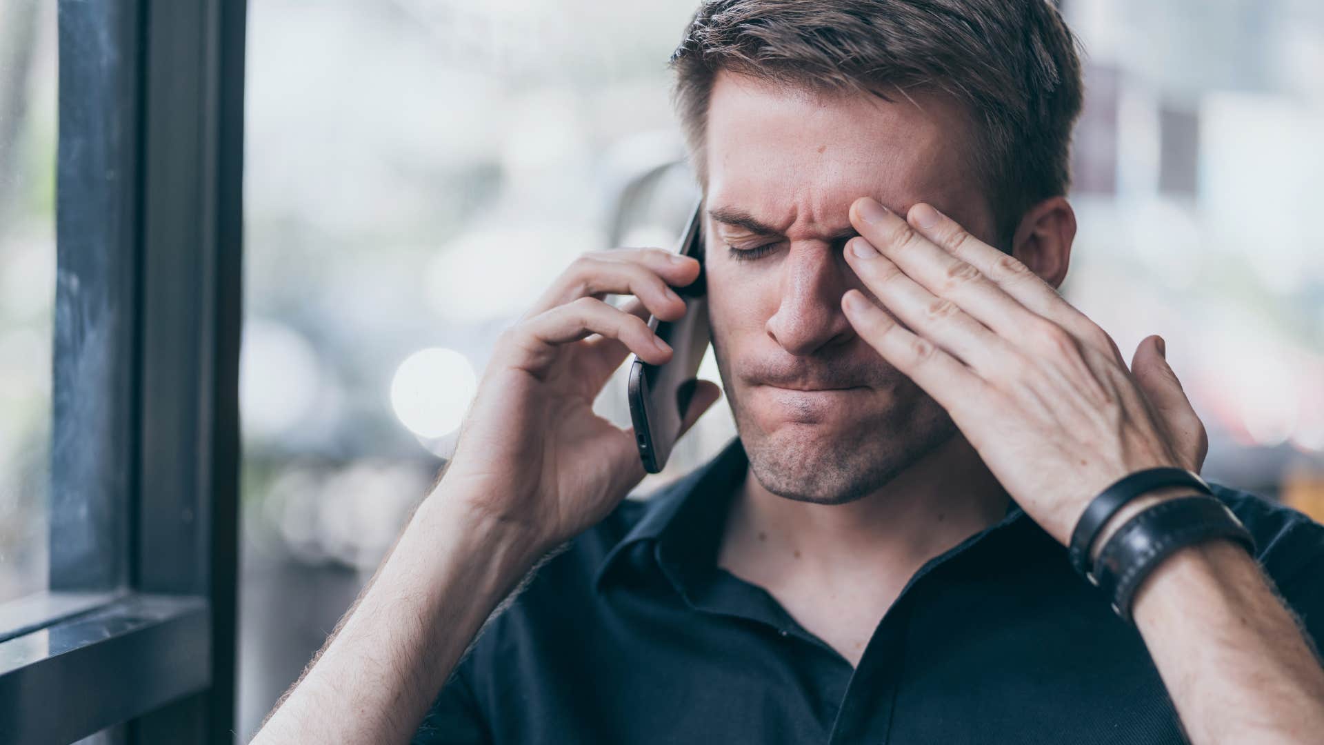 Man who struggles with reading the room talking on the phone.