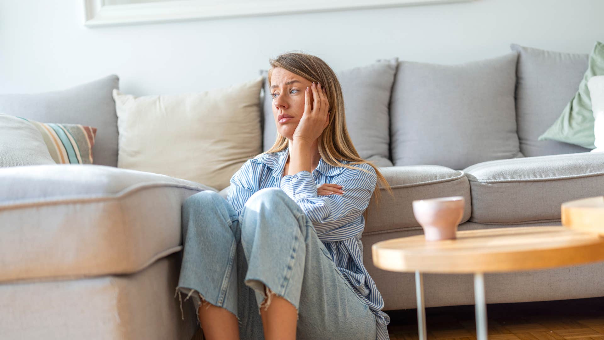 woman sitting alone on floor of living room