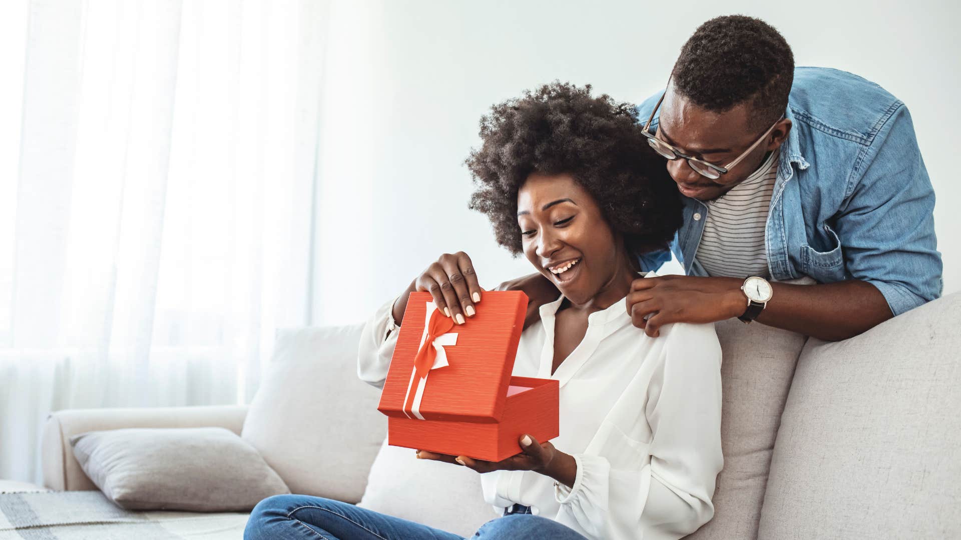 Happy woman receives meaningful gift showing way to tell he loves you