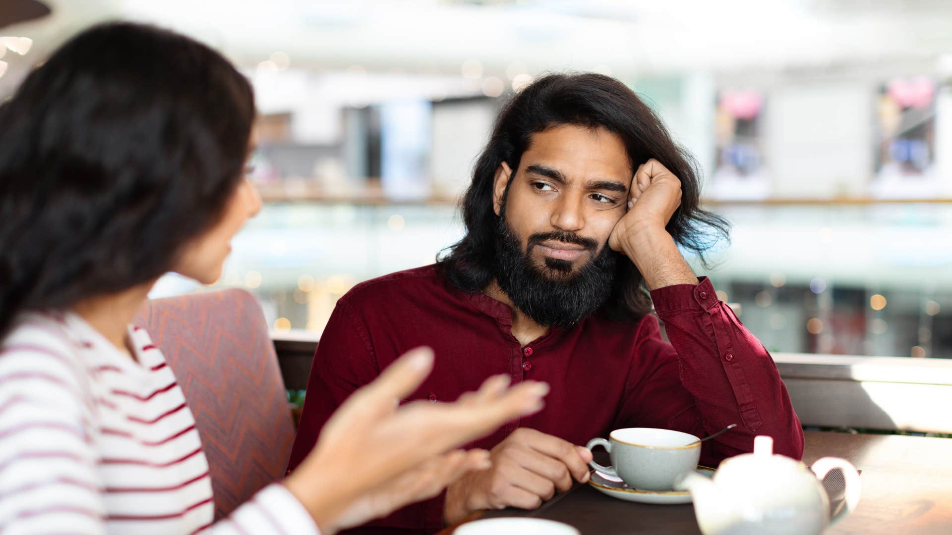 Uncertain man plays with own hair showing way to tell he loves you