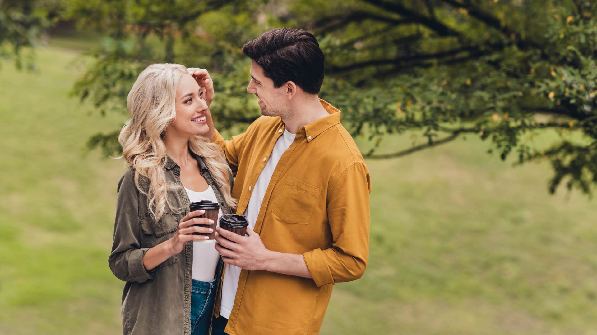 Upright man gently touches woman showing way to tell he loves you