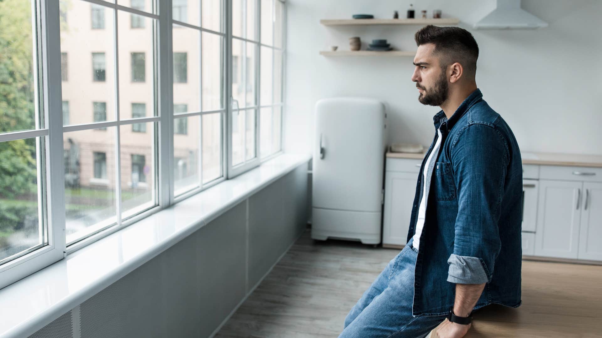 man standing in kitchen that lacks personal identity
