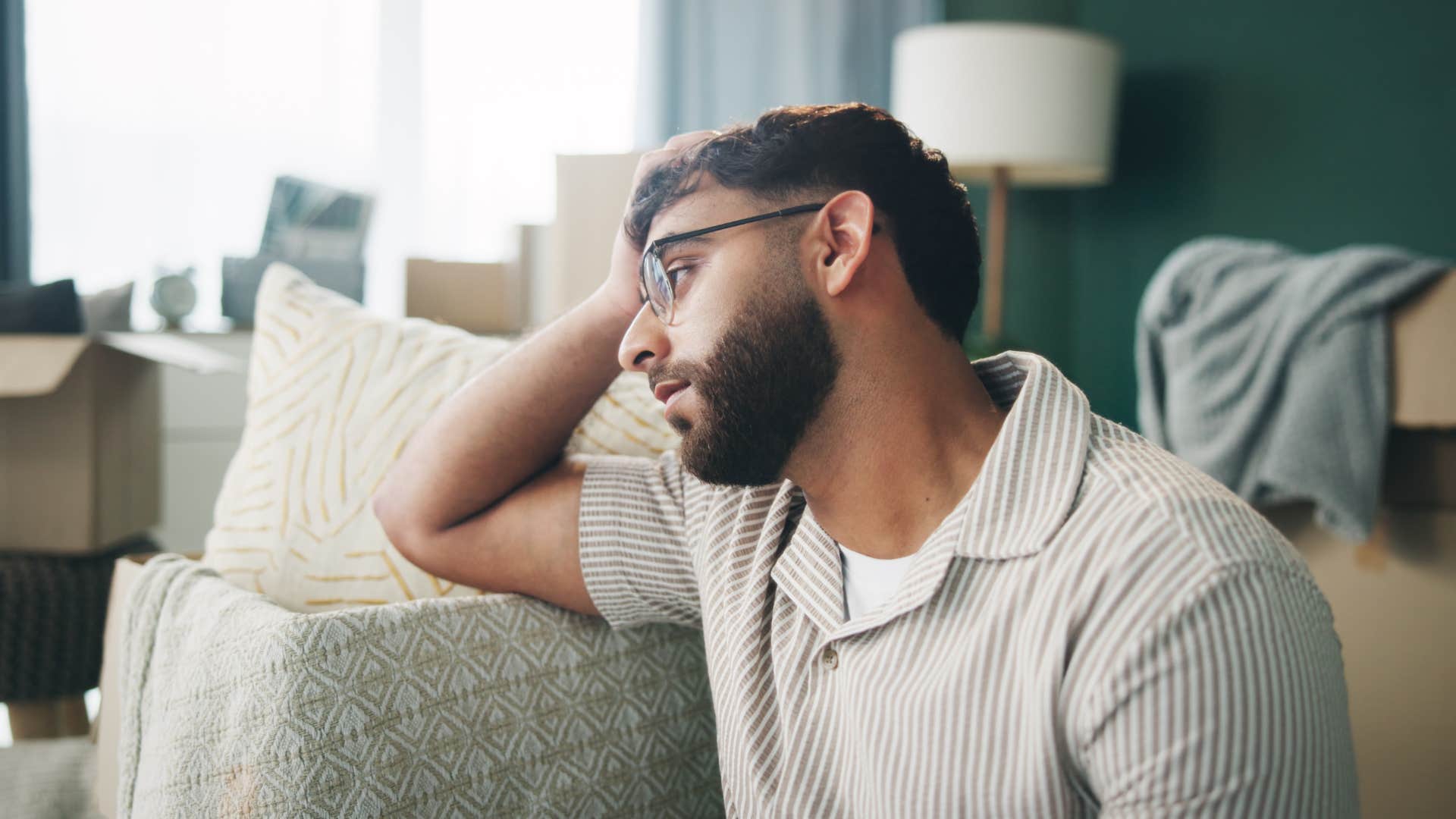 man whose life is collapsing sitting in stale home