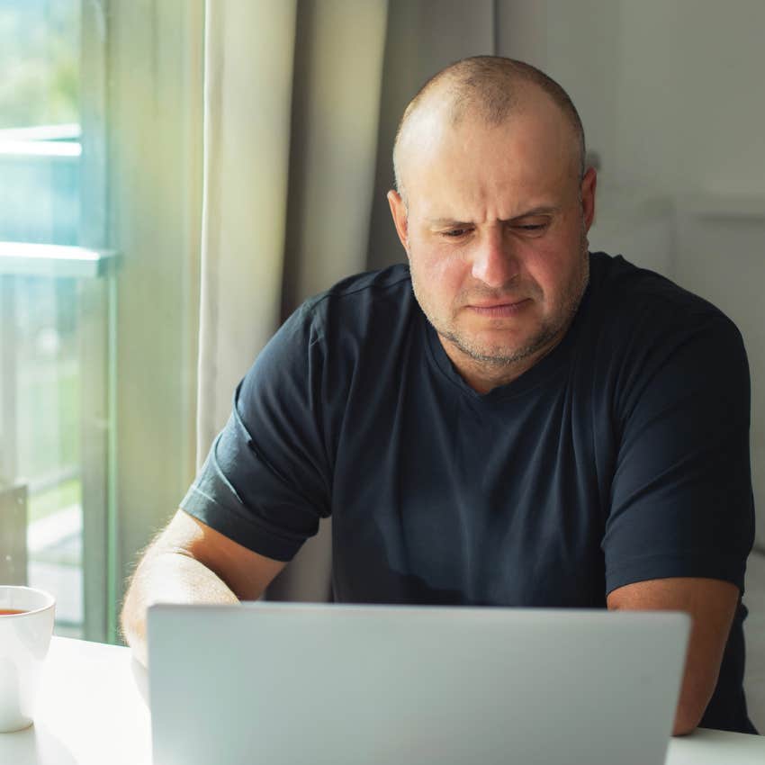 Man sitting in a house with a lack of art.