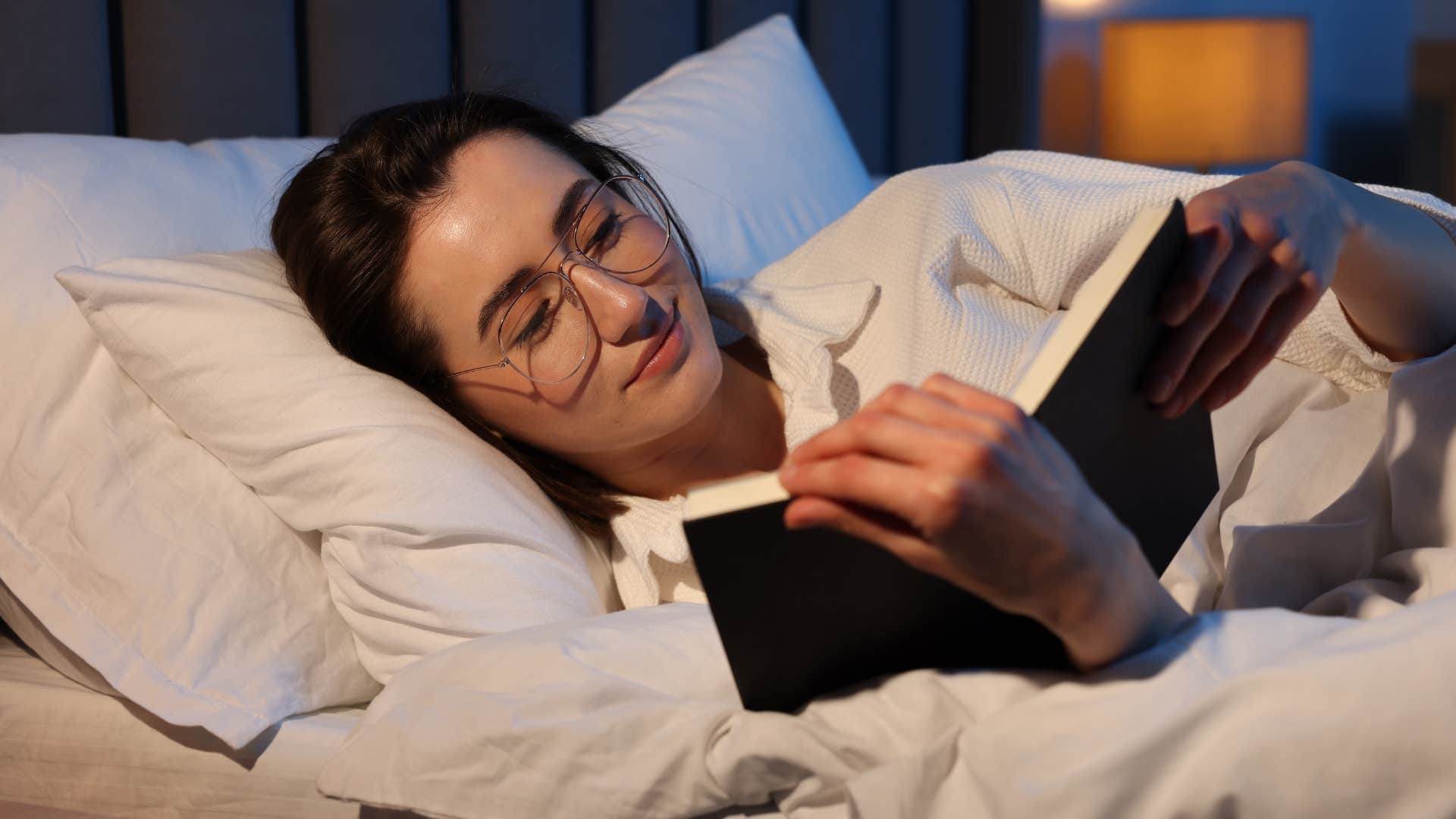 woman reading in her bedroom that revolves around rest