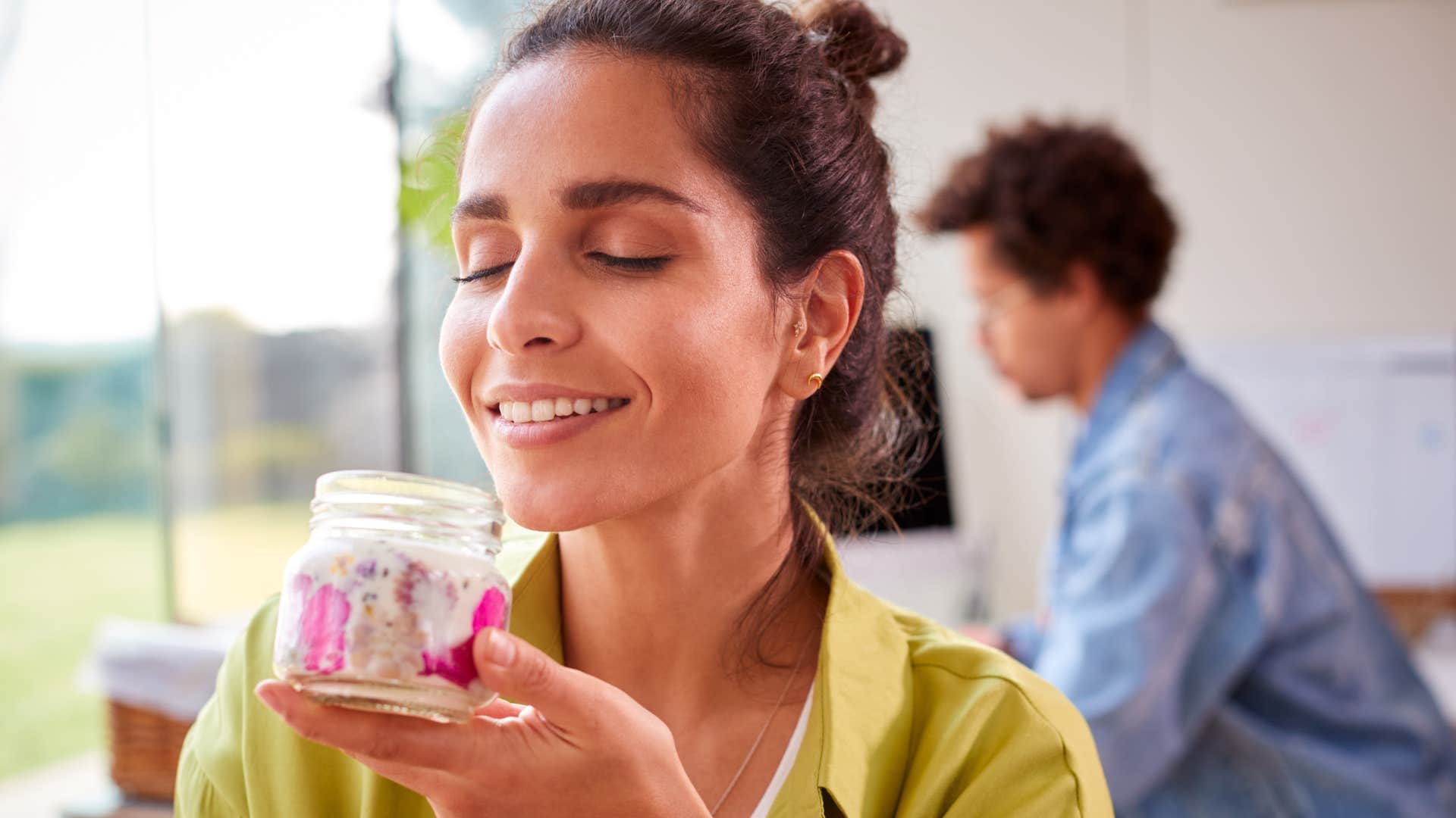 woman at home smelling her used candles