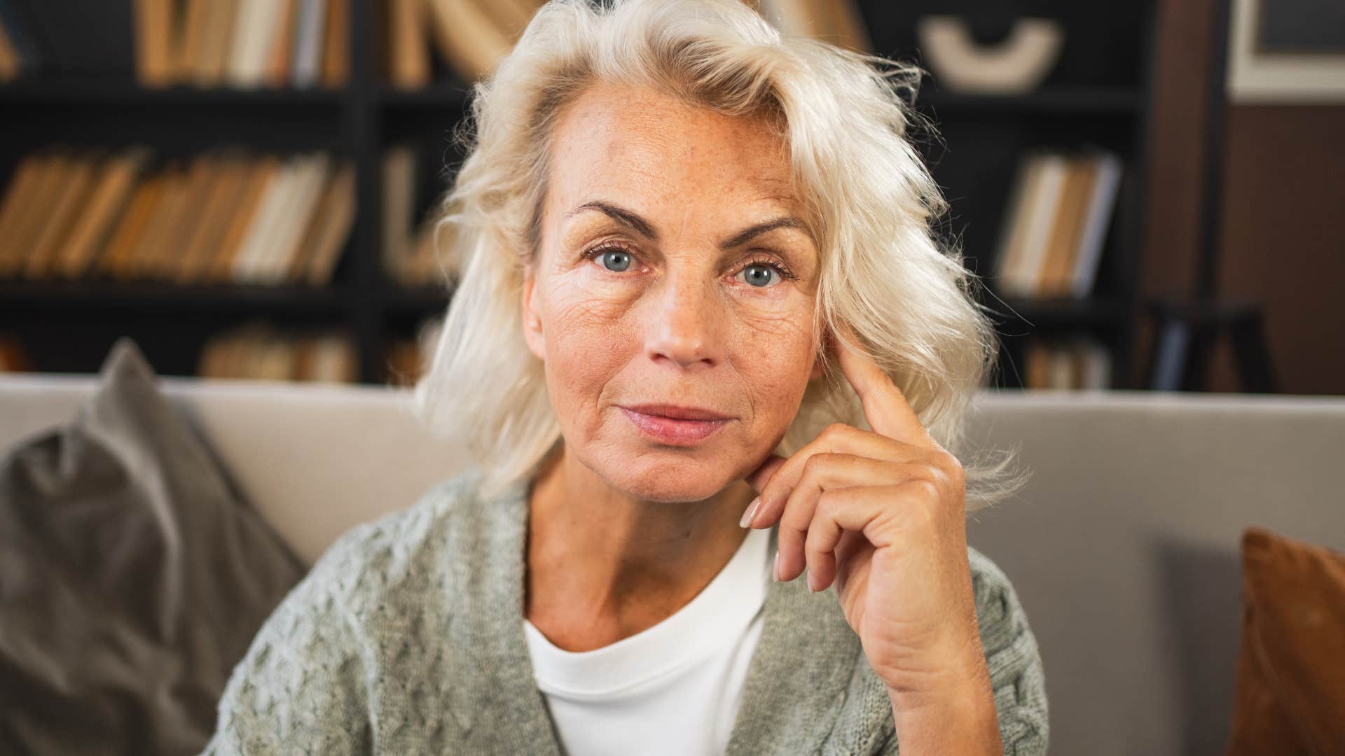 older woman on phone living in a home where everything feels like a time capsule