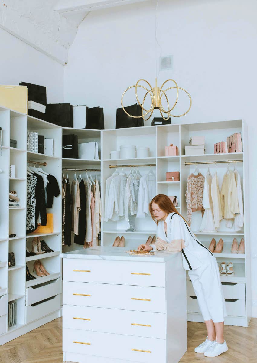 young woman standing in a walk-in closet