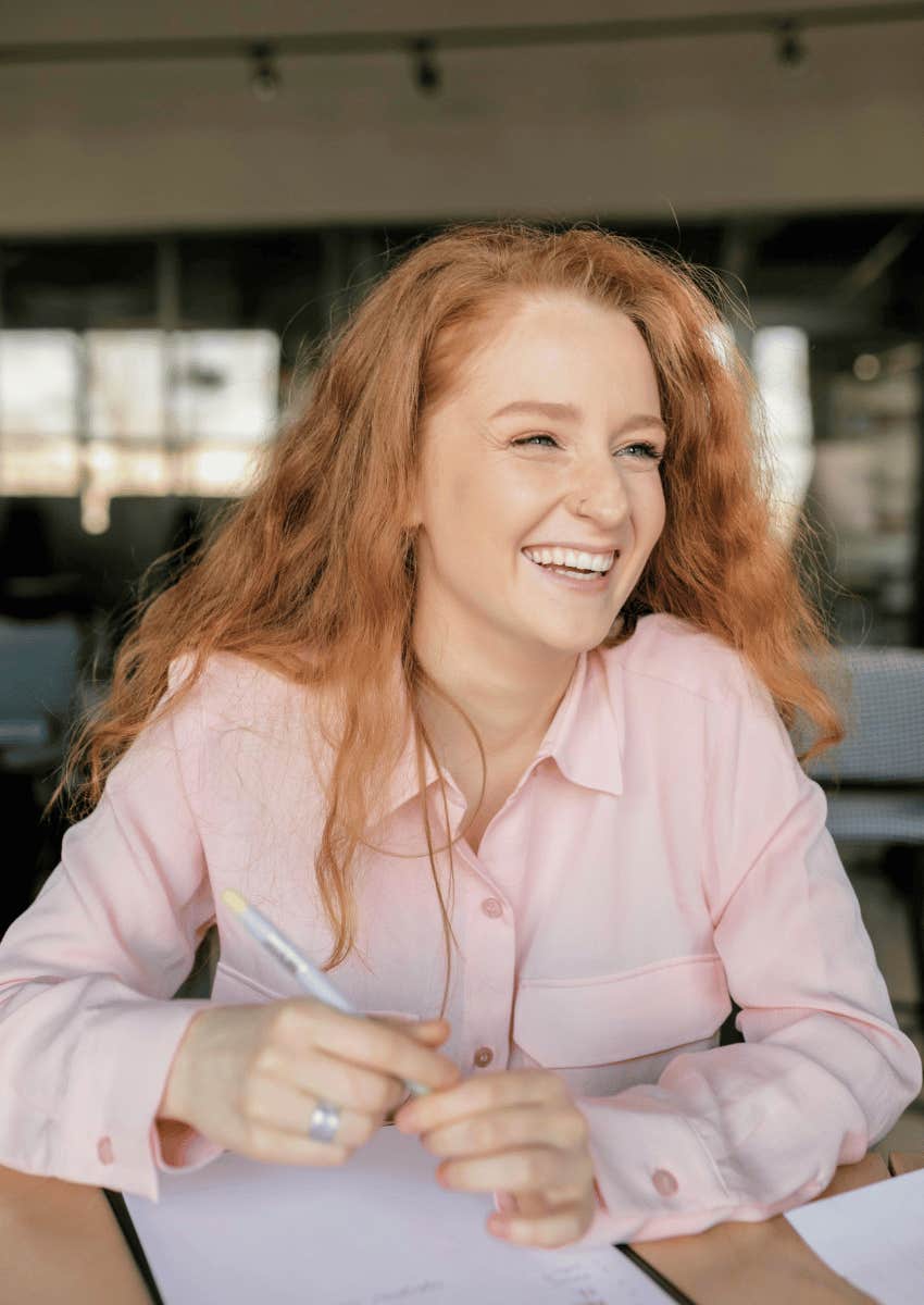 young woman with red hair employee smiling
