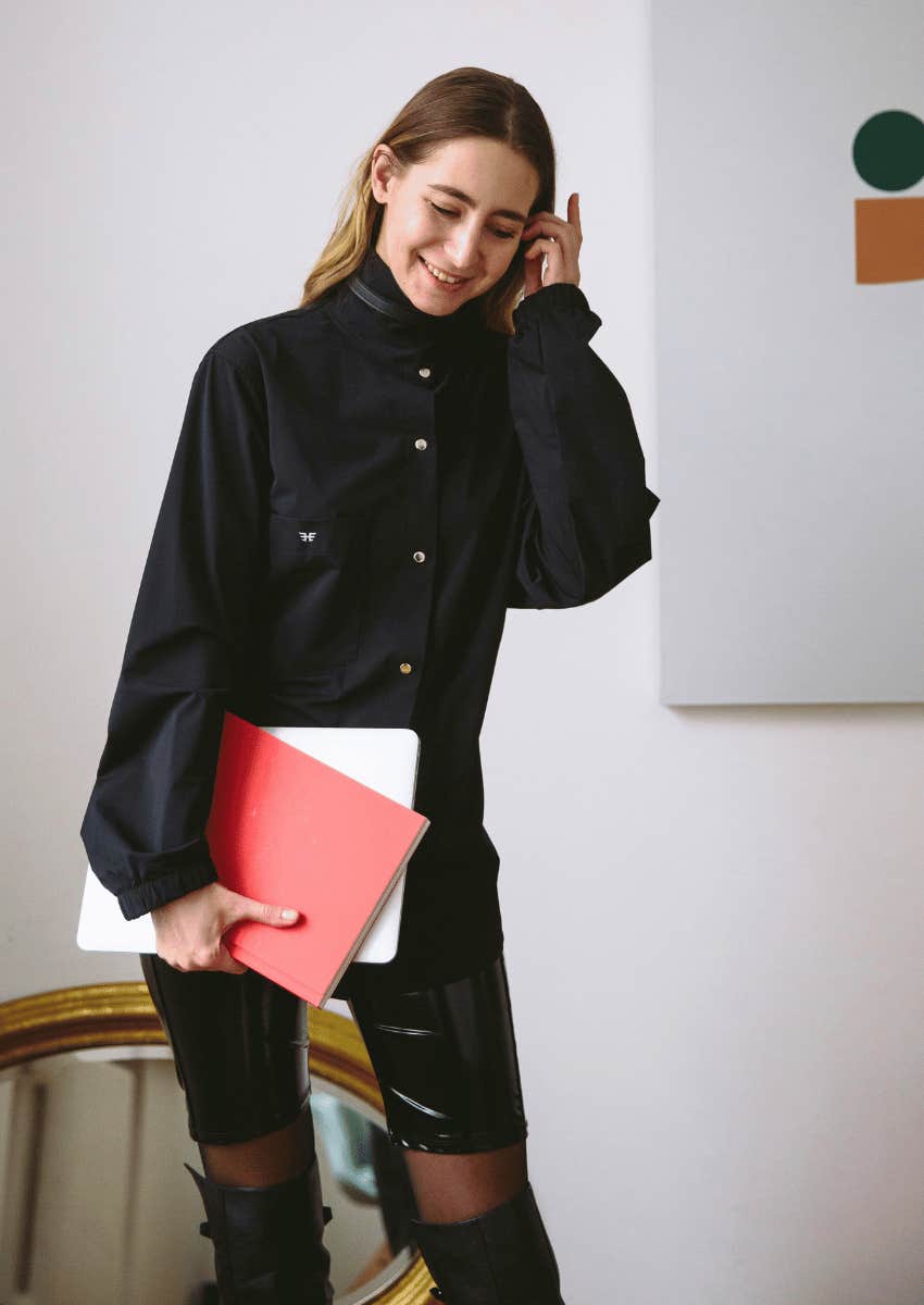 young woman with a shy smile looking down