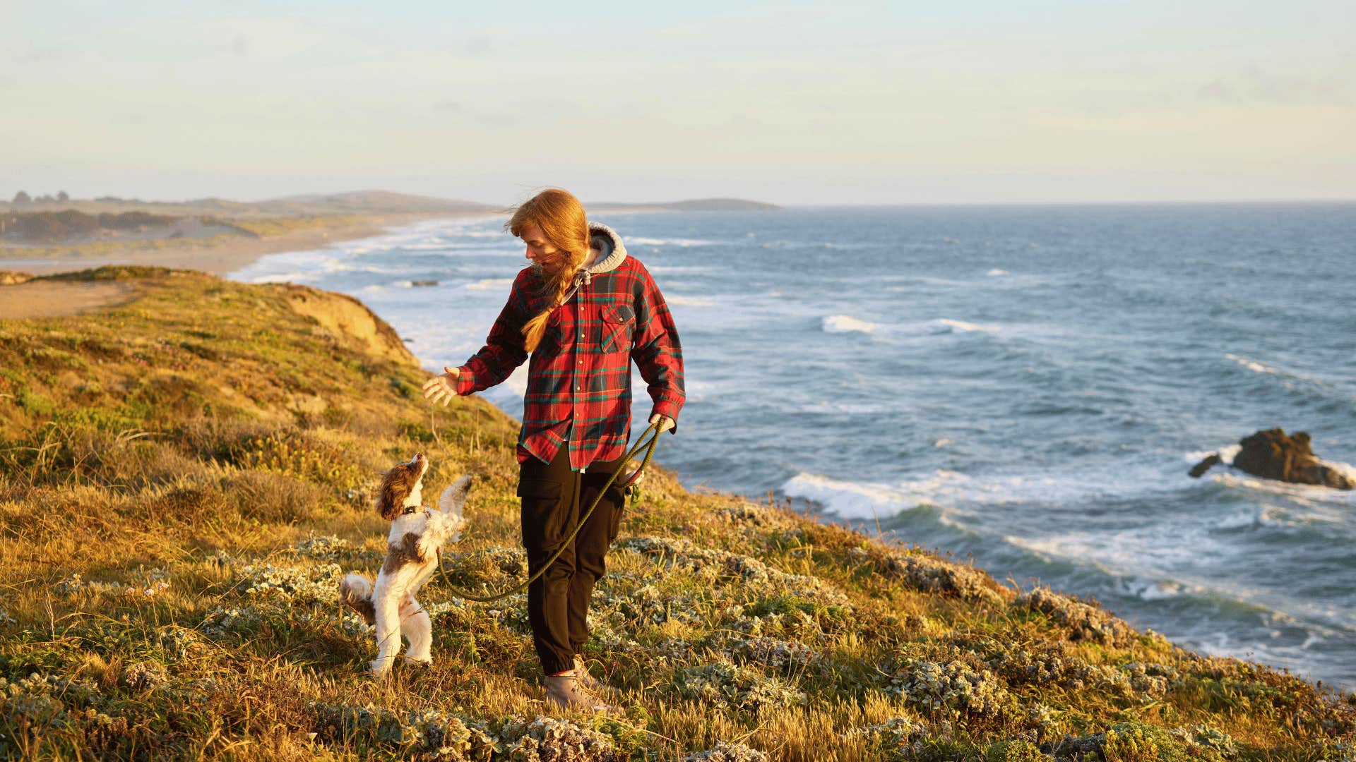 young woman spending time in nature with her pet