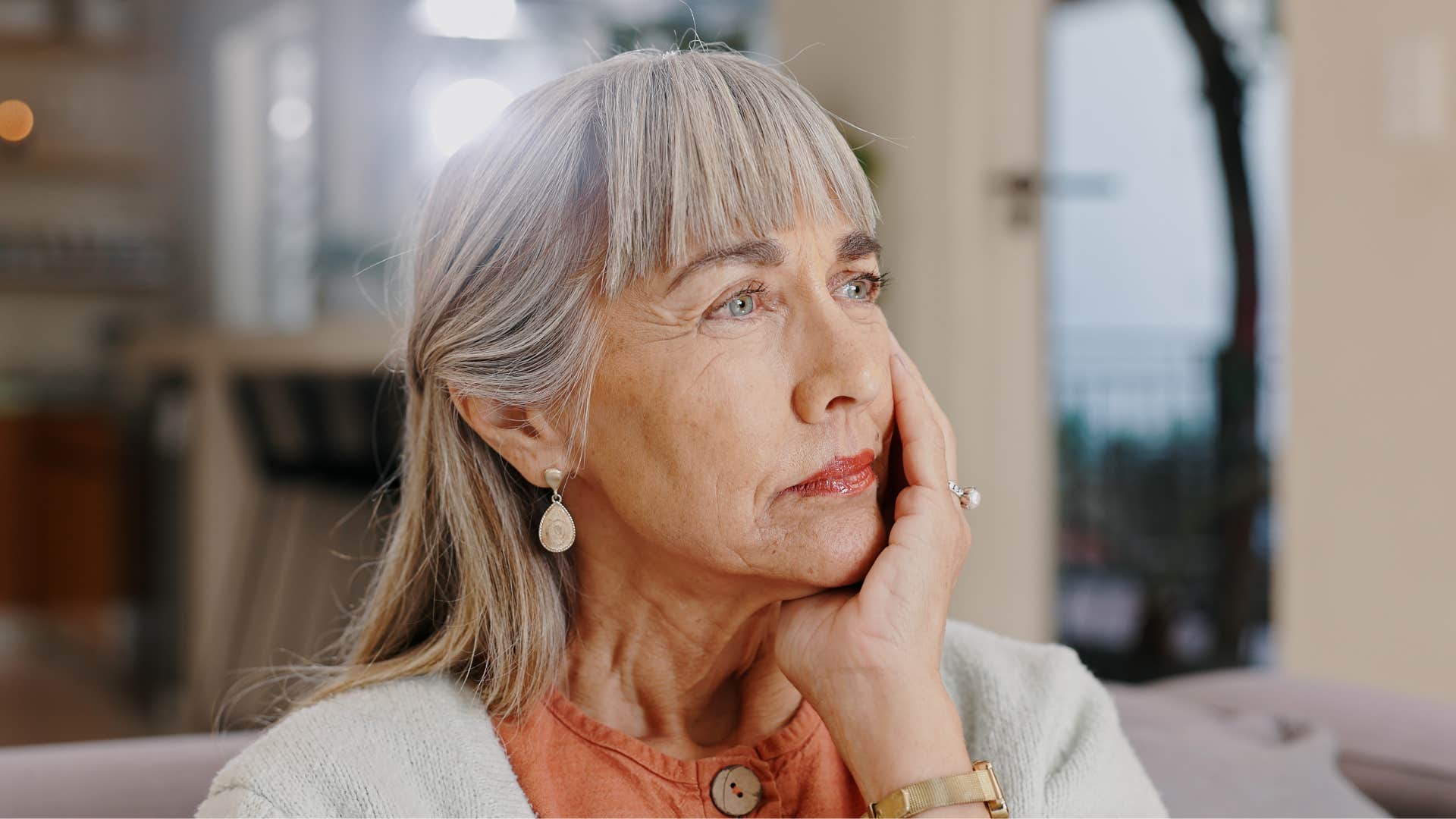 Contemplative person rest chin on head showing grief after divorce