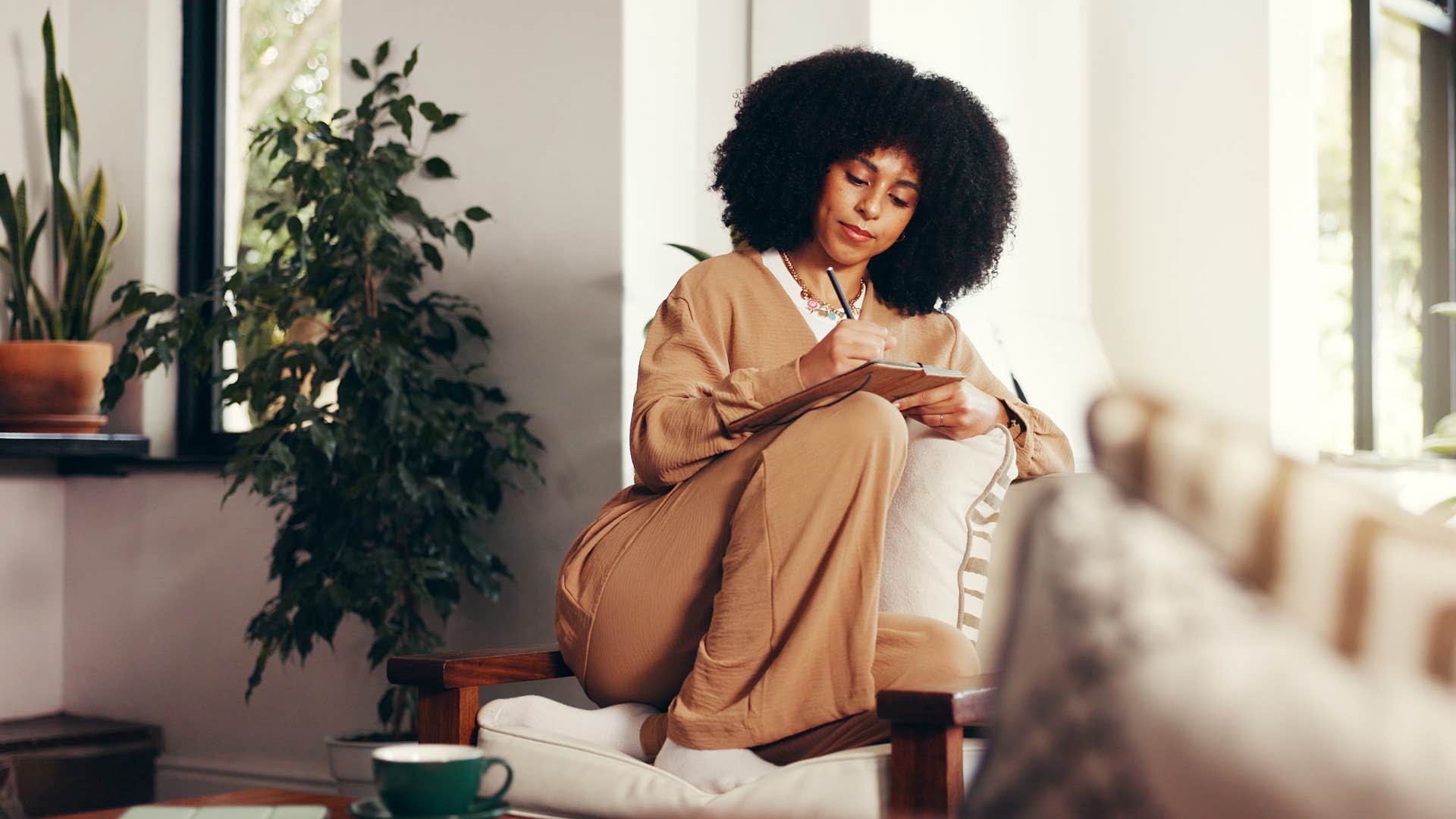 Focused person writes priorities in notebook showing way to get better at life